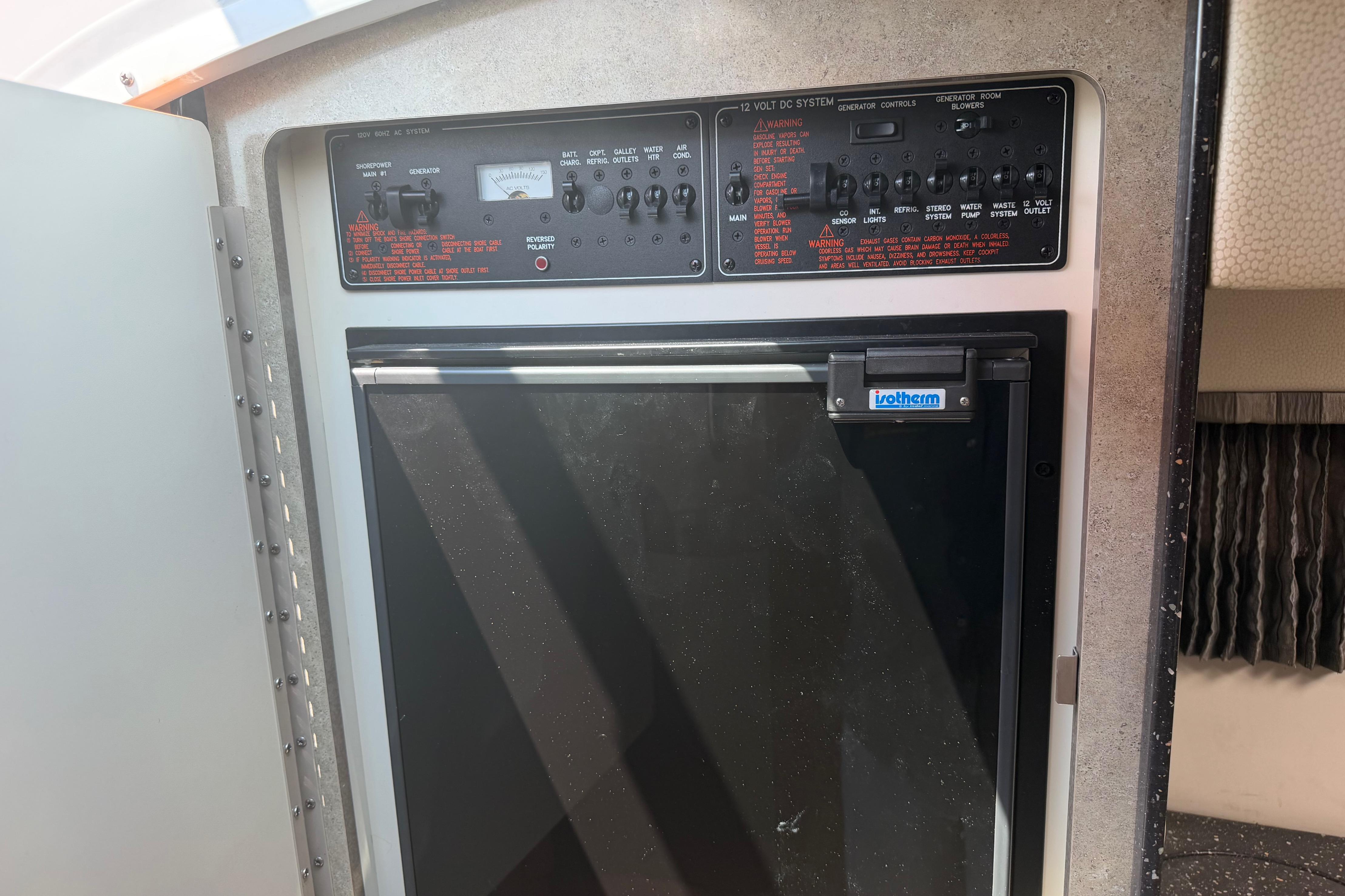 Control panel and refrigerator inside a 2006 Formula 330 Sun Sport boat.
