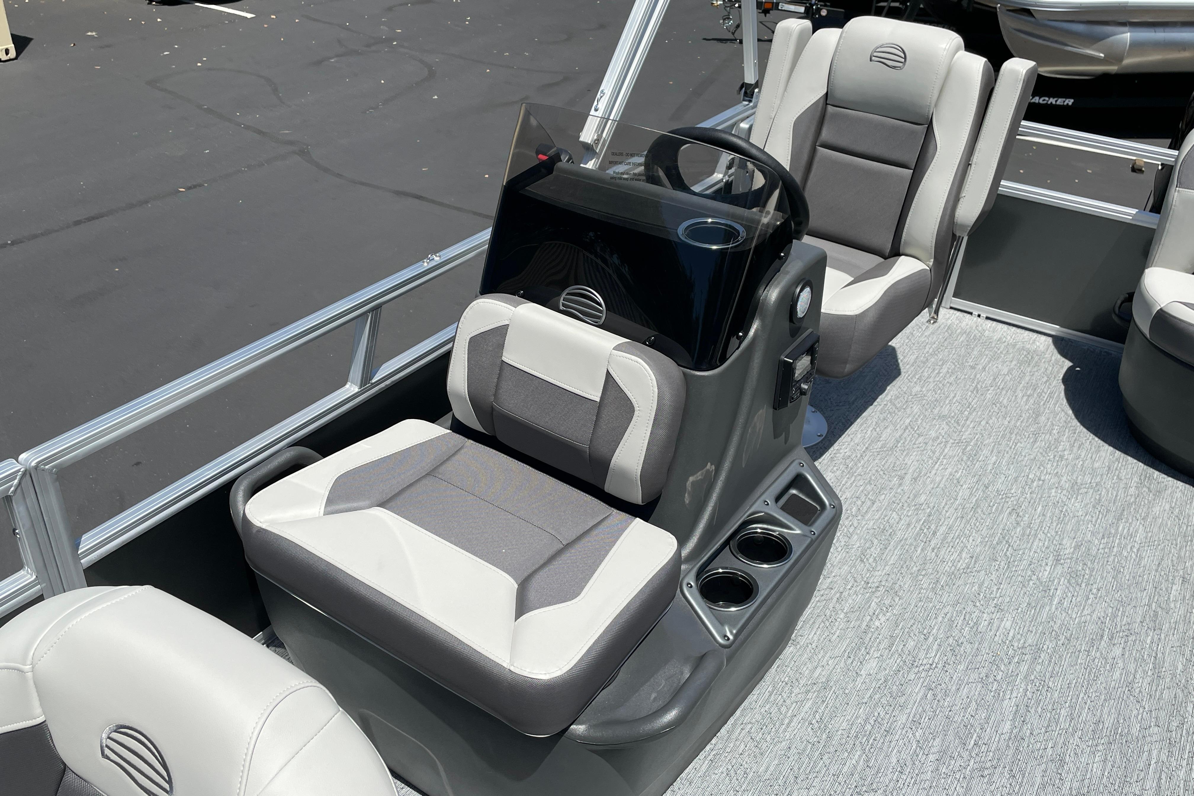 2026 Sun Tracker Bass Buggy 16 XL Select interior with gray seating and steering console.