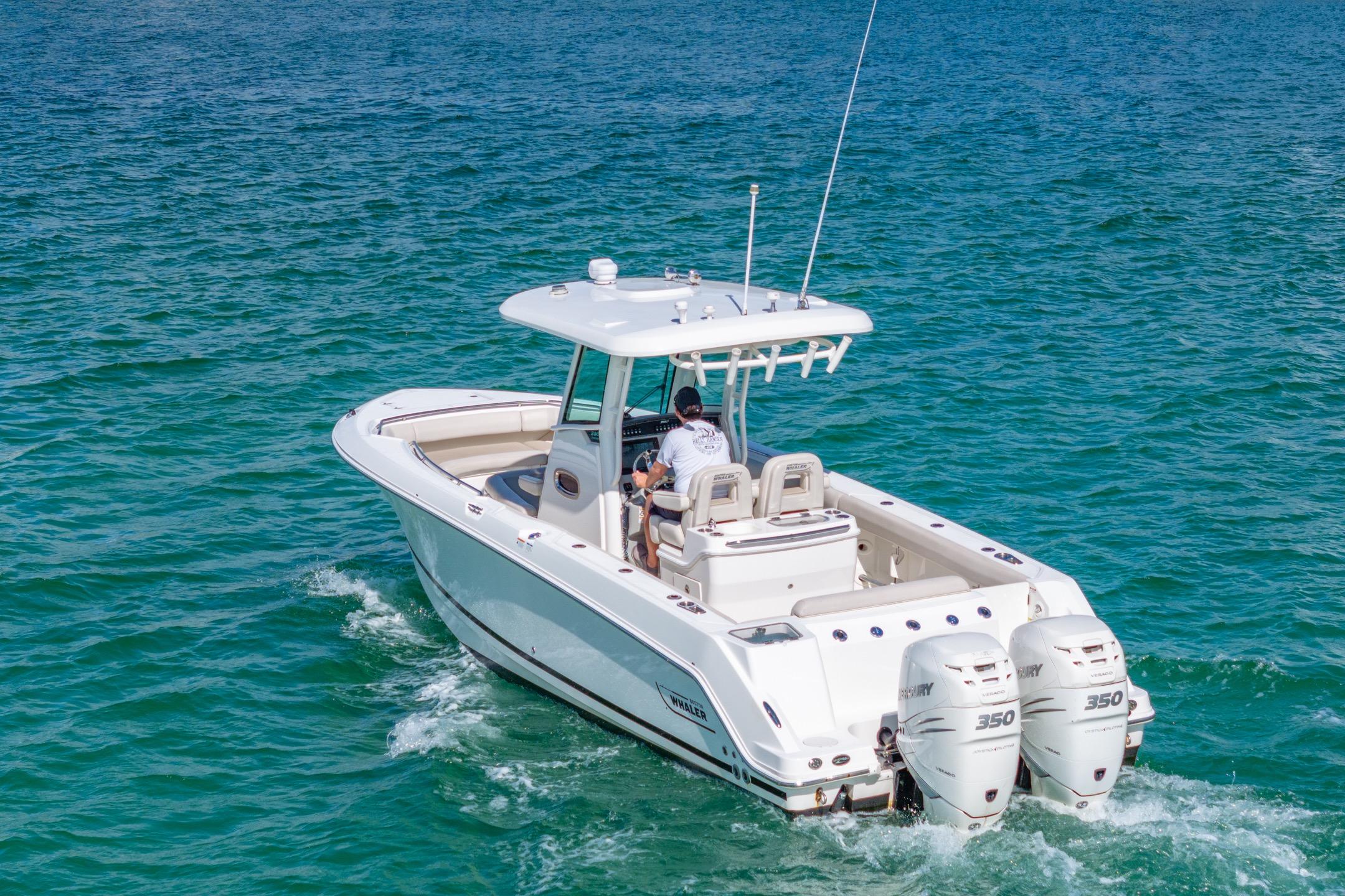 2016 Boston Whaler 280 Outrage boat cruising on clear blue water.