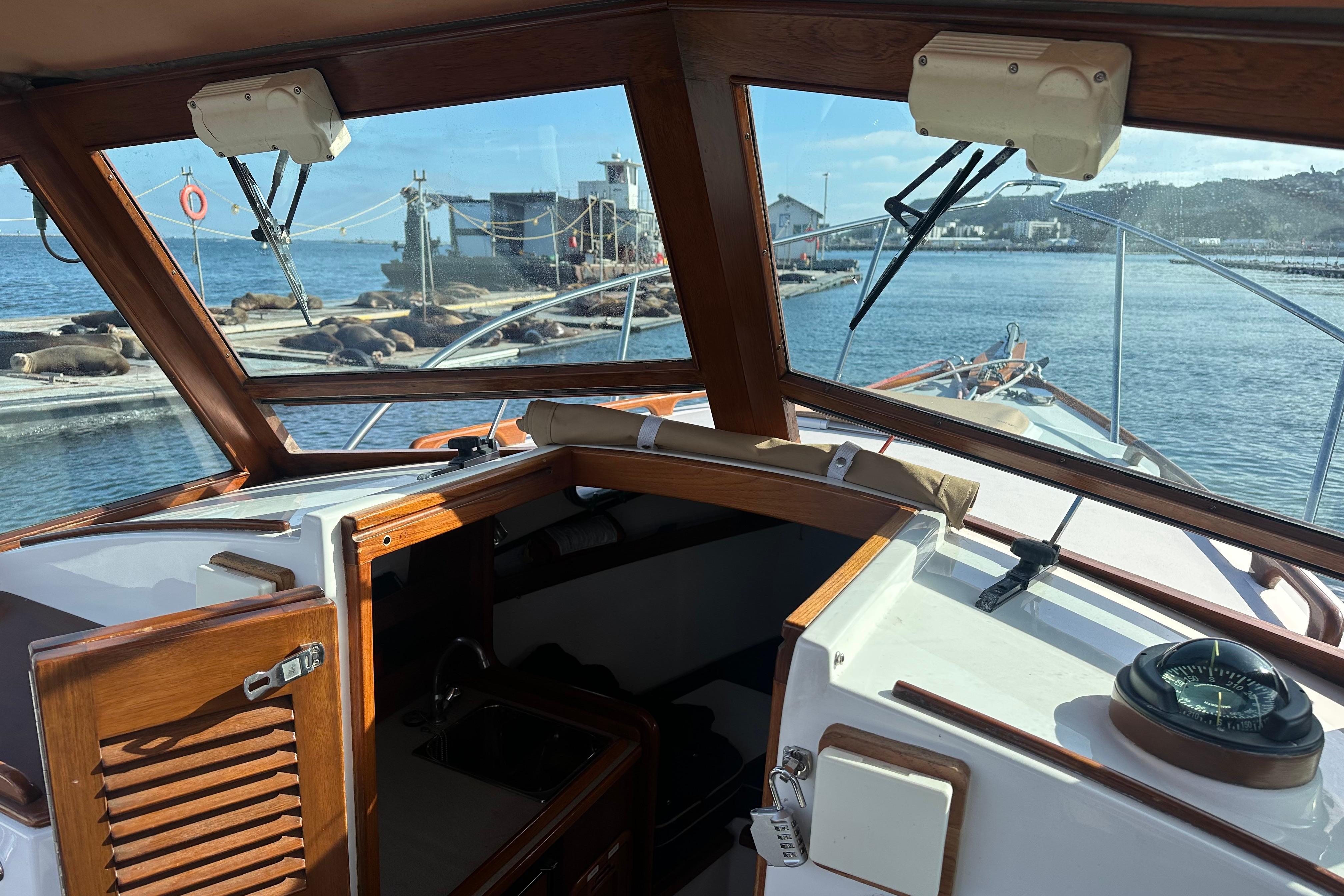 2008 Wasque 26 boat interior with sea lions on dock in background.