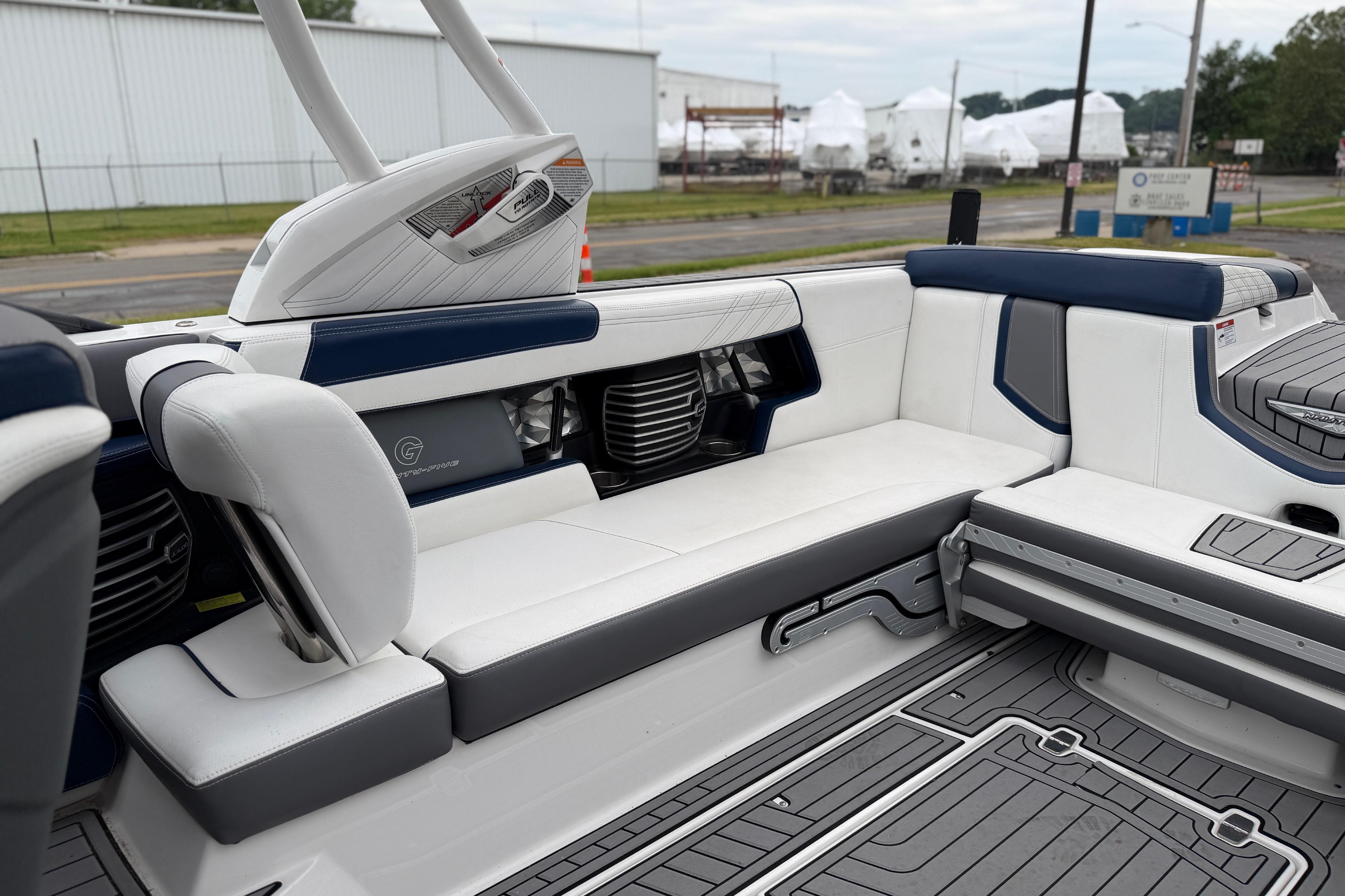 2016 Naitique G25 boat interior with white and blue seating, showcasing modern design.