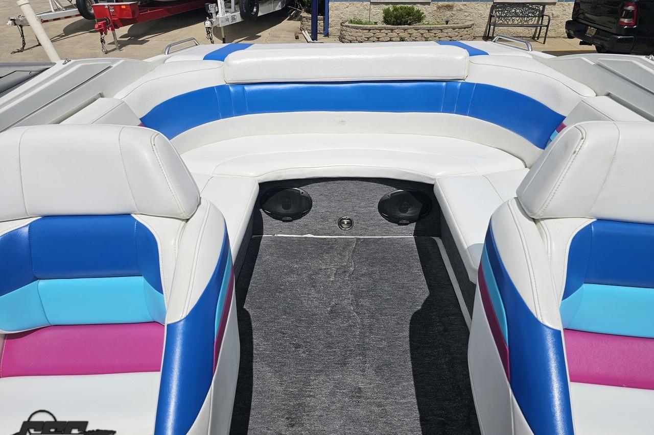 1997 Formula 252 SS boat interior with colorful seating and carpeted floor.