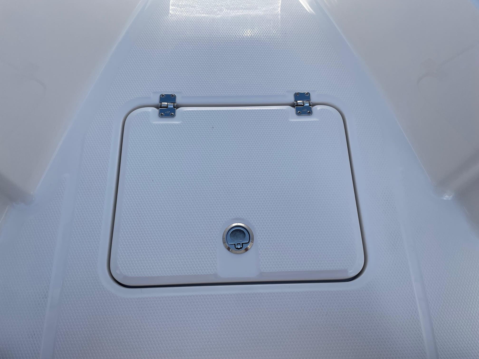 2025 Robalo R230 Center Console storage hatch with secure latch and hinges.
