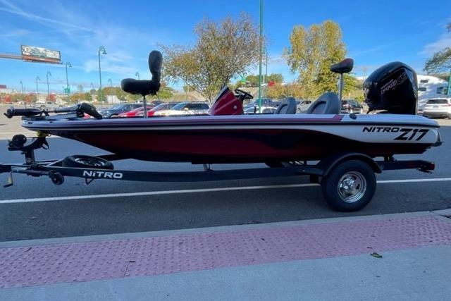 2026 Nitro Z17 boat on trailer, parked outdoors, showcasing sleek design and modern features.
