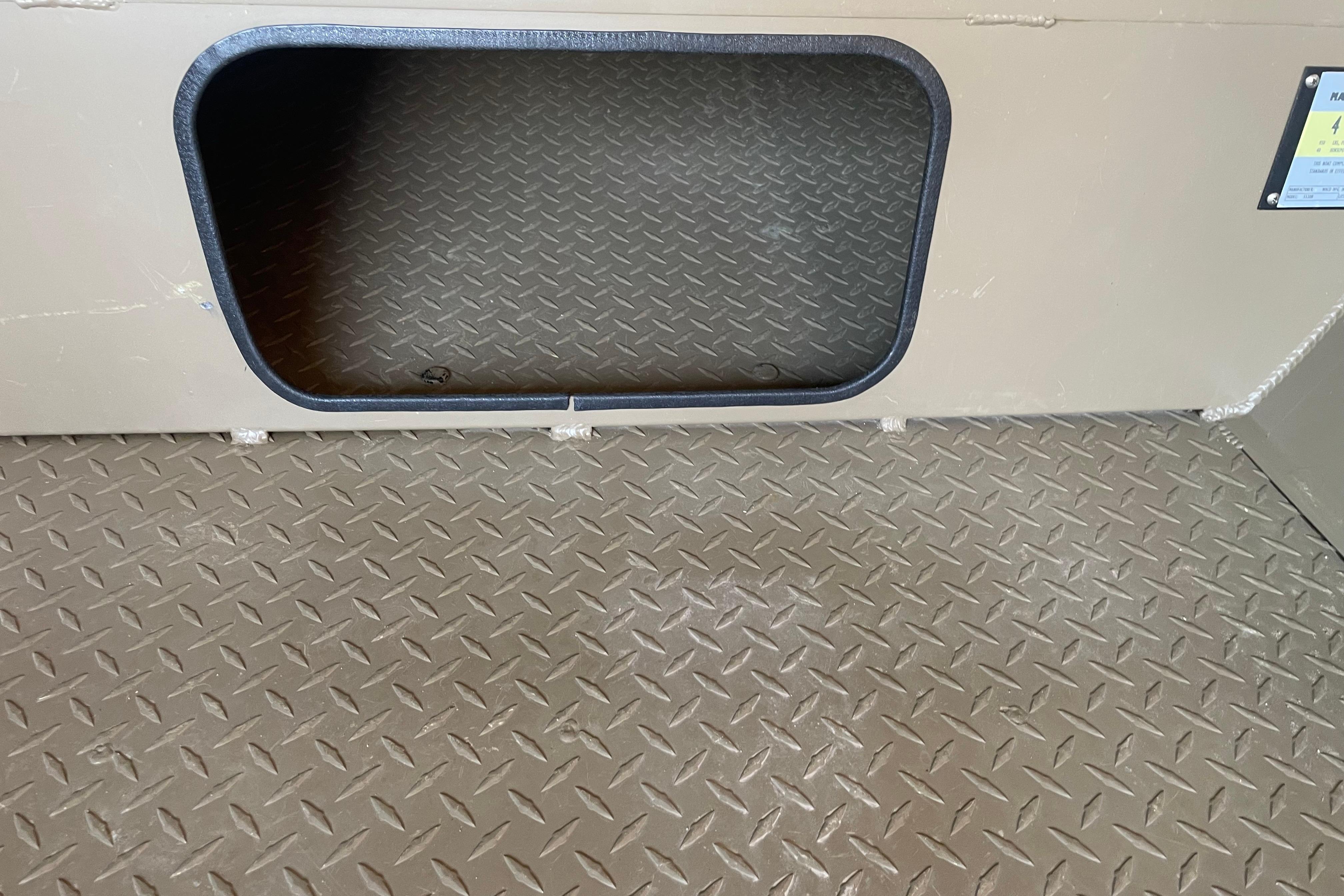 Diamond plate flooring and storage compartment in 2025 Edge Duck Boats 550.