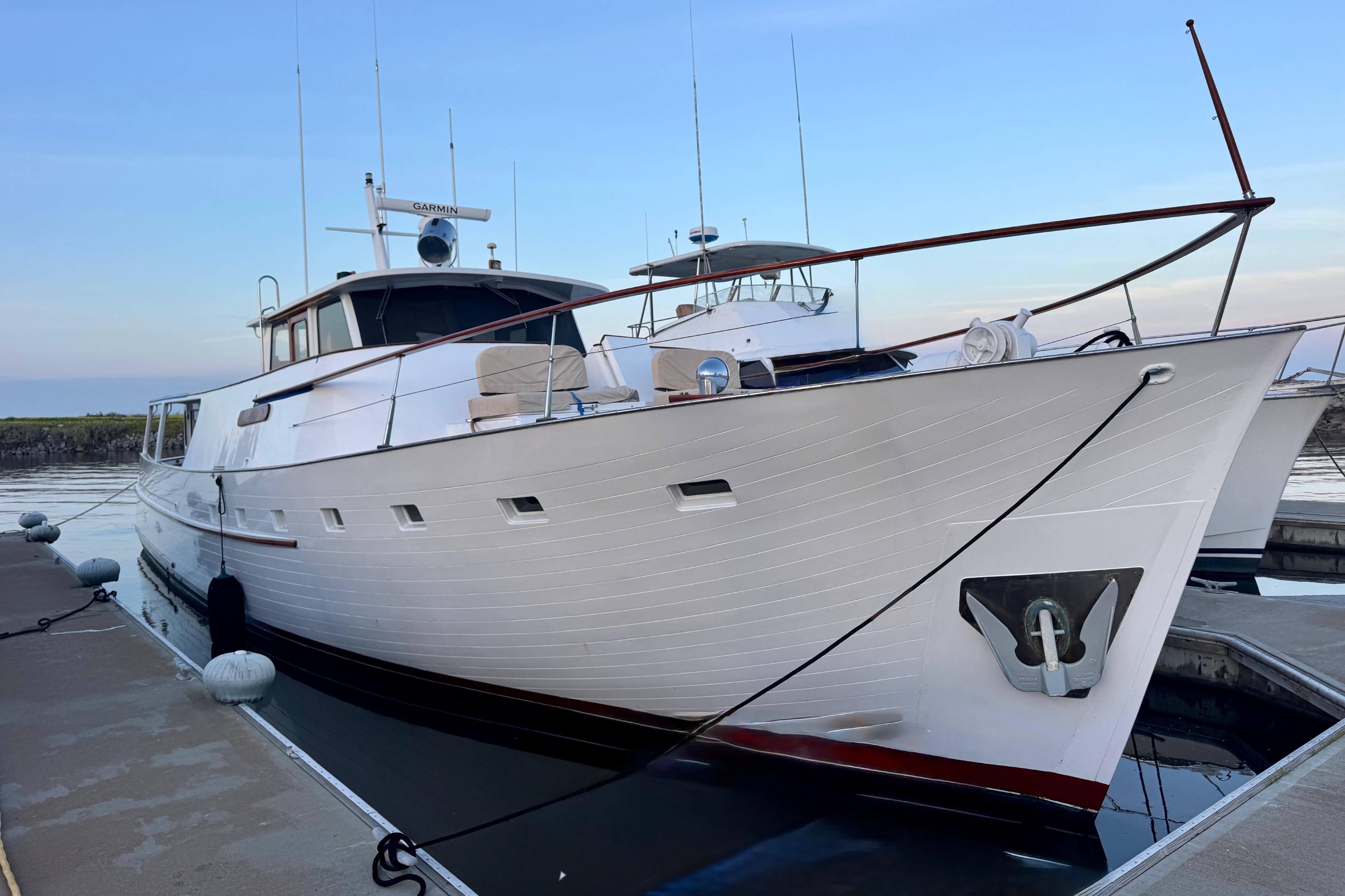 1958 Blanchard Pilothouse yacht docked at marina, showcasing classic design and elegant lines.