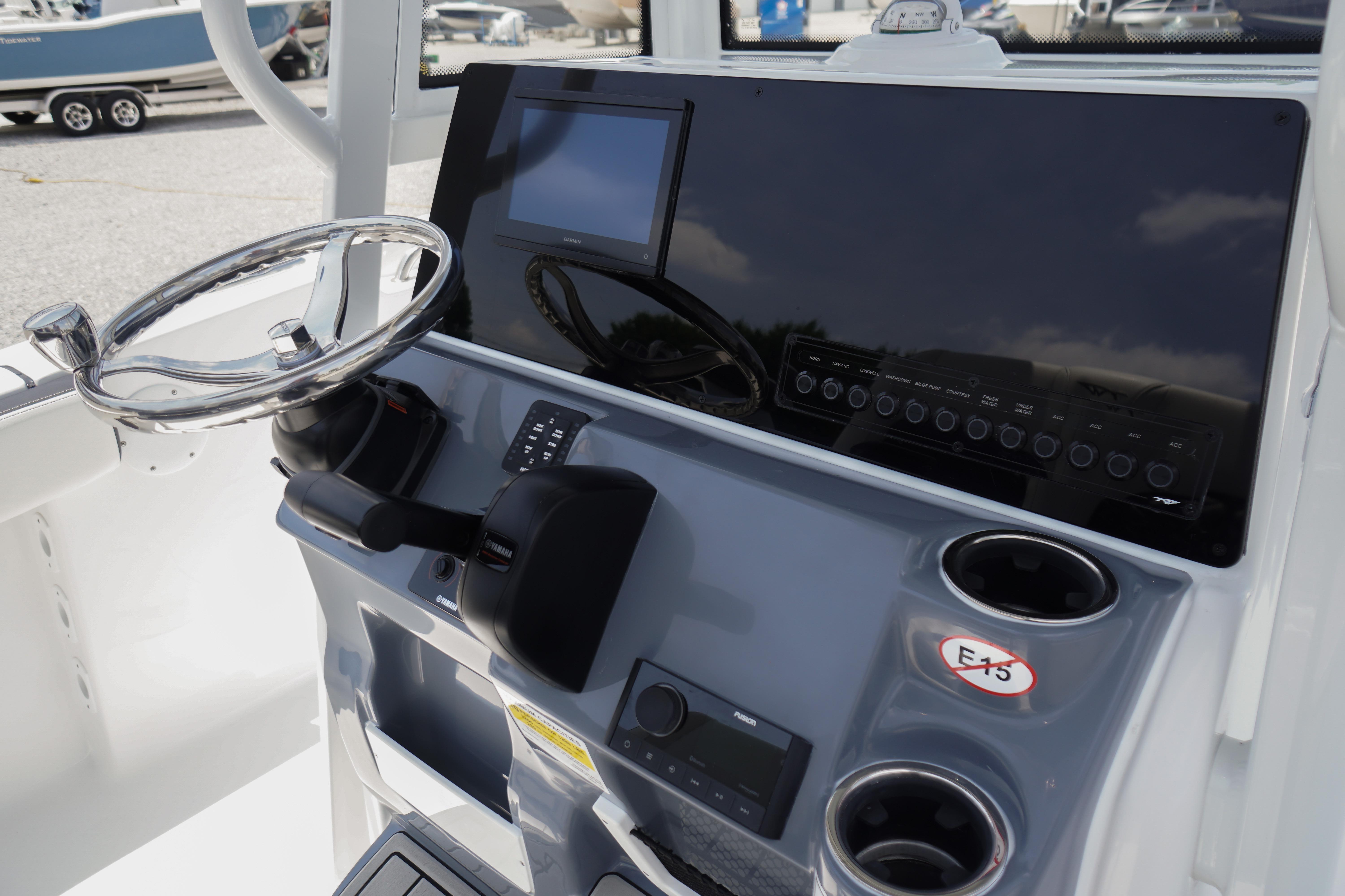 2027 Tidewater 220 CC Adventure boat dashboard with steering wheel and controls.