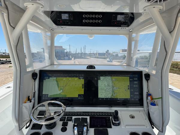 Cockpit of 2022 Freeman 42LR boat with dual navigation screens and steering wheel.