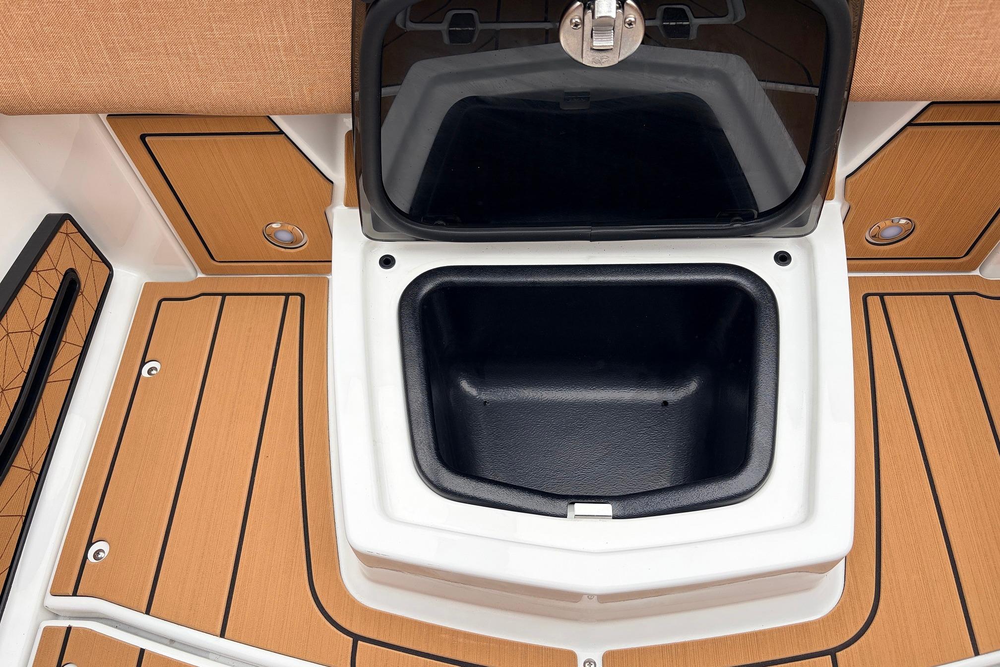 2026 Nautique Super Air Nautique G25 storage compartment with teak-style flooring.