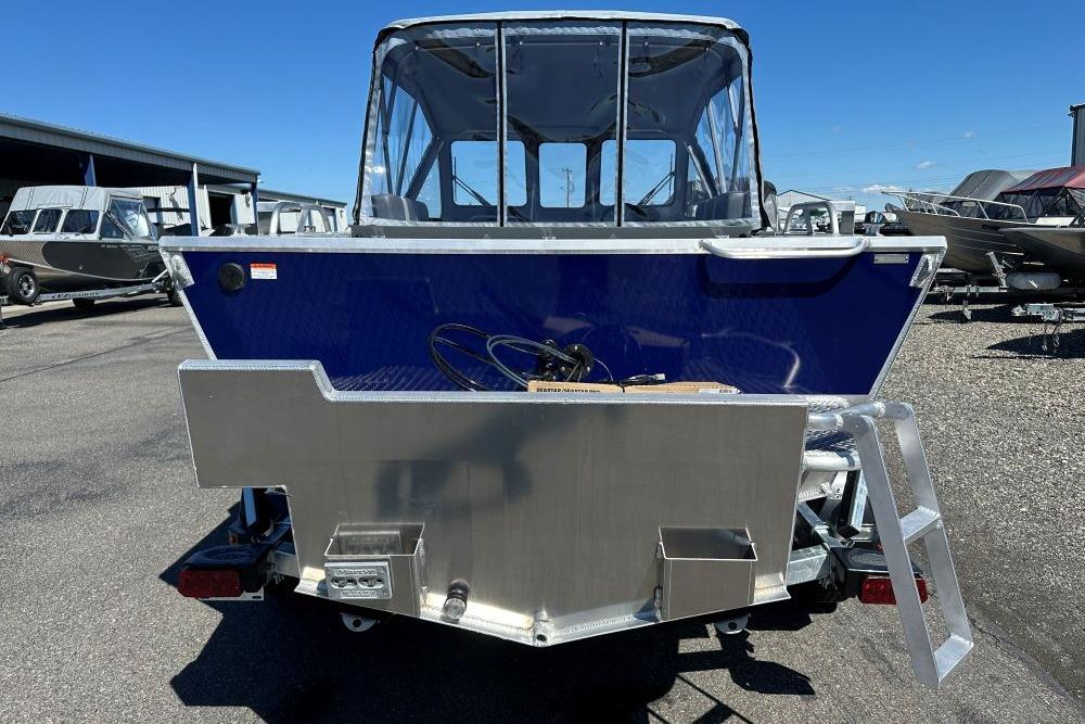 2026 Hewescraft 180 ProV ET boat, rear view, in a marina setting.