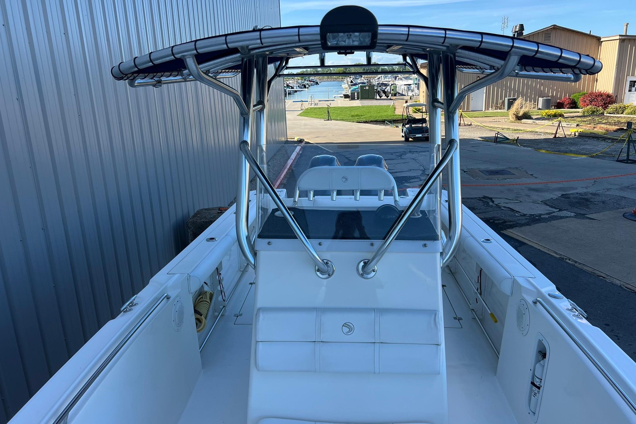 2006 Edgewater 245CC boat docked, featuring a sleek center console design.