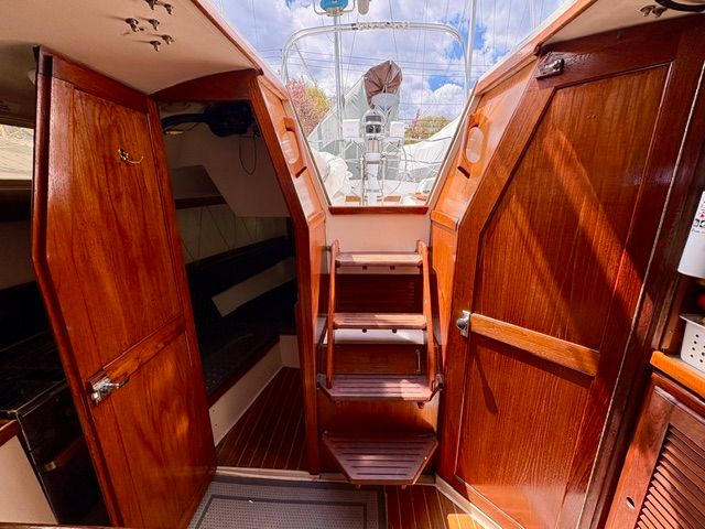 Interior of a 1989 Catalina 34 with wooden doors and stairs.