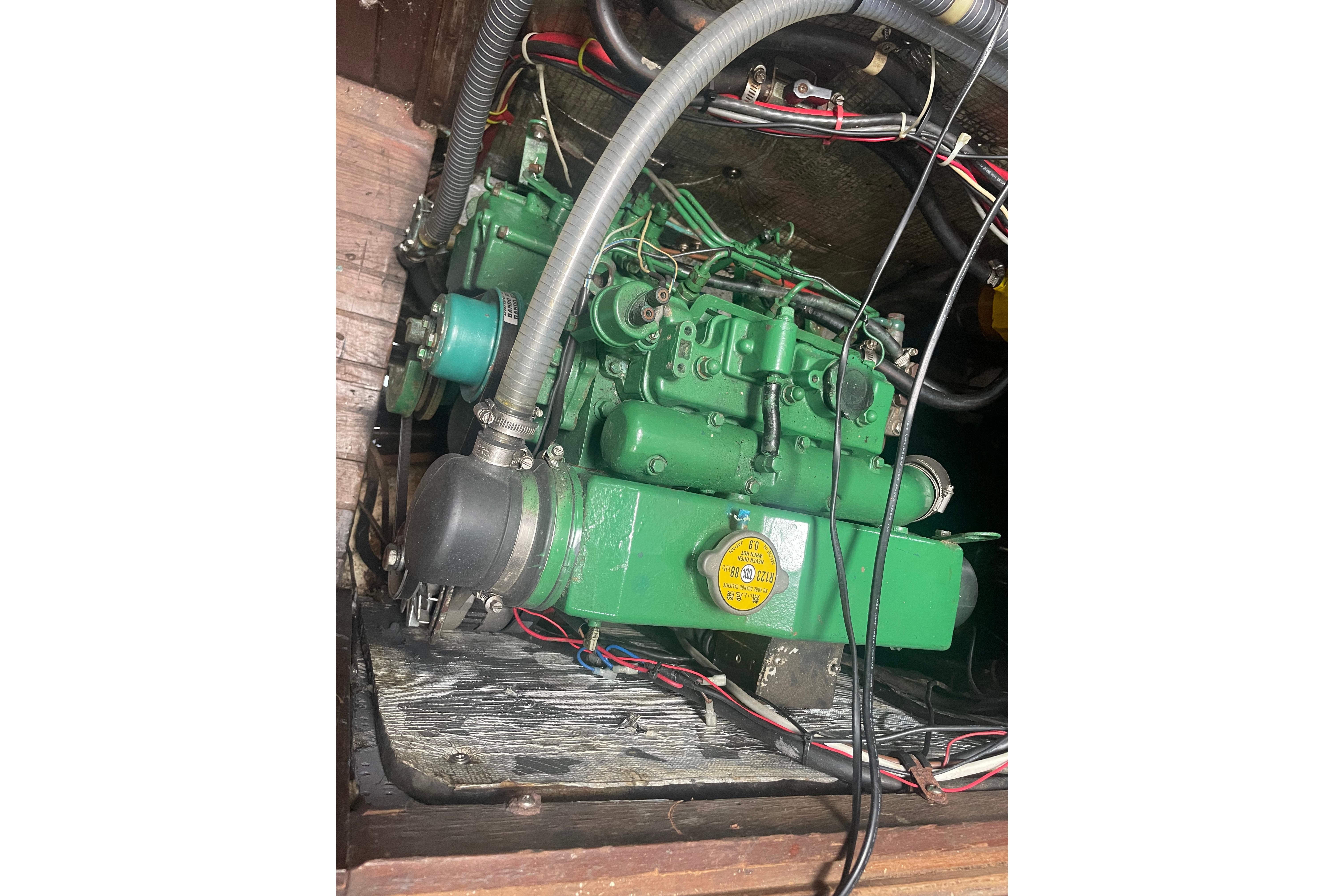 Green engine inside a 1979 Westwind 35 boat, showing wiring and components.