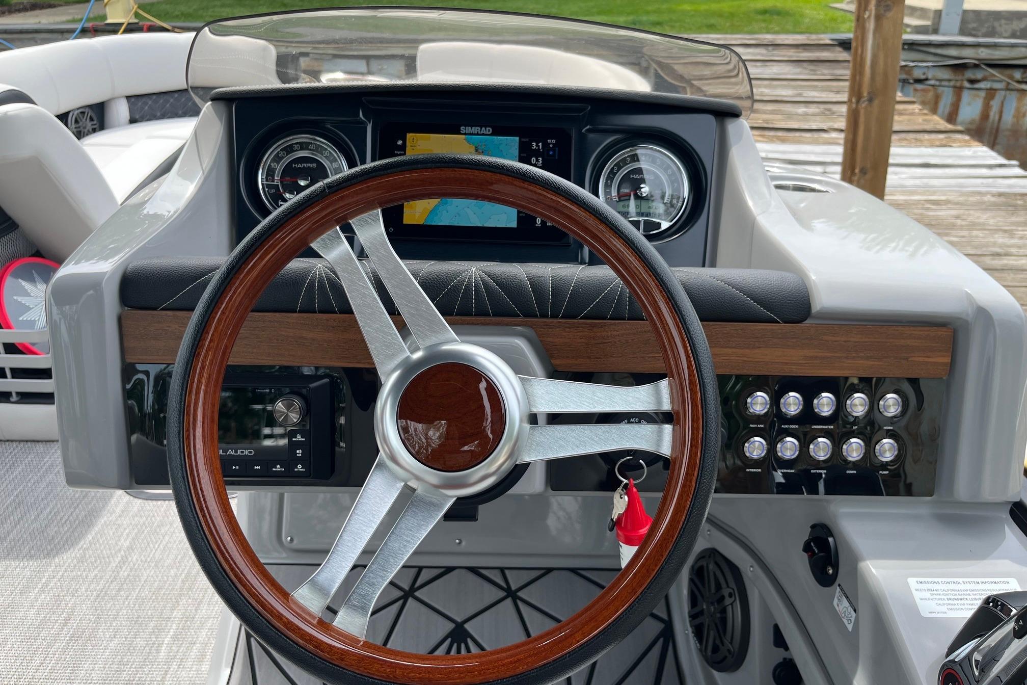 2024 Harris Grand Mariner 250 dashboard with wood-accented steering wheel and modern controls.