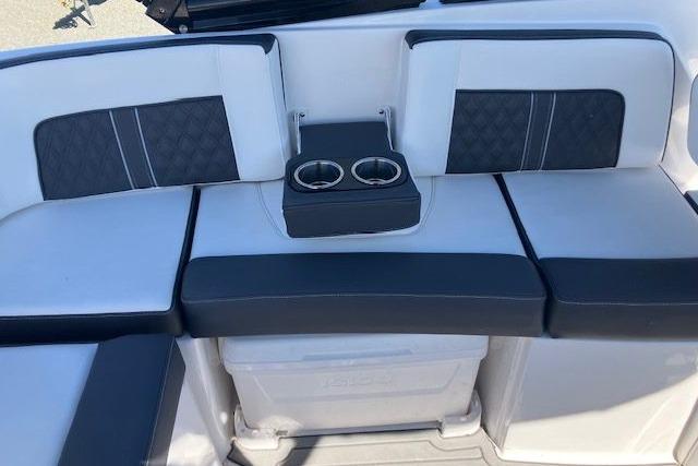 2024 Monterey M-65 boat seating with cup holders, featuring stylish black and white upholstery.