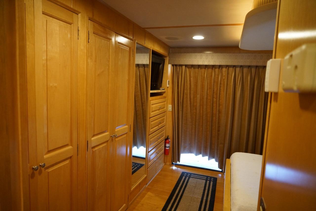 Interior of 2000 Stardust Cruisers houseboat with wood paneling and cozy furnishings.