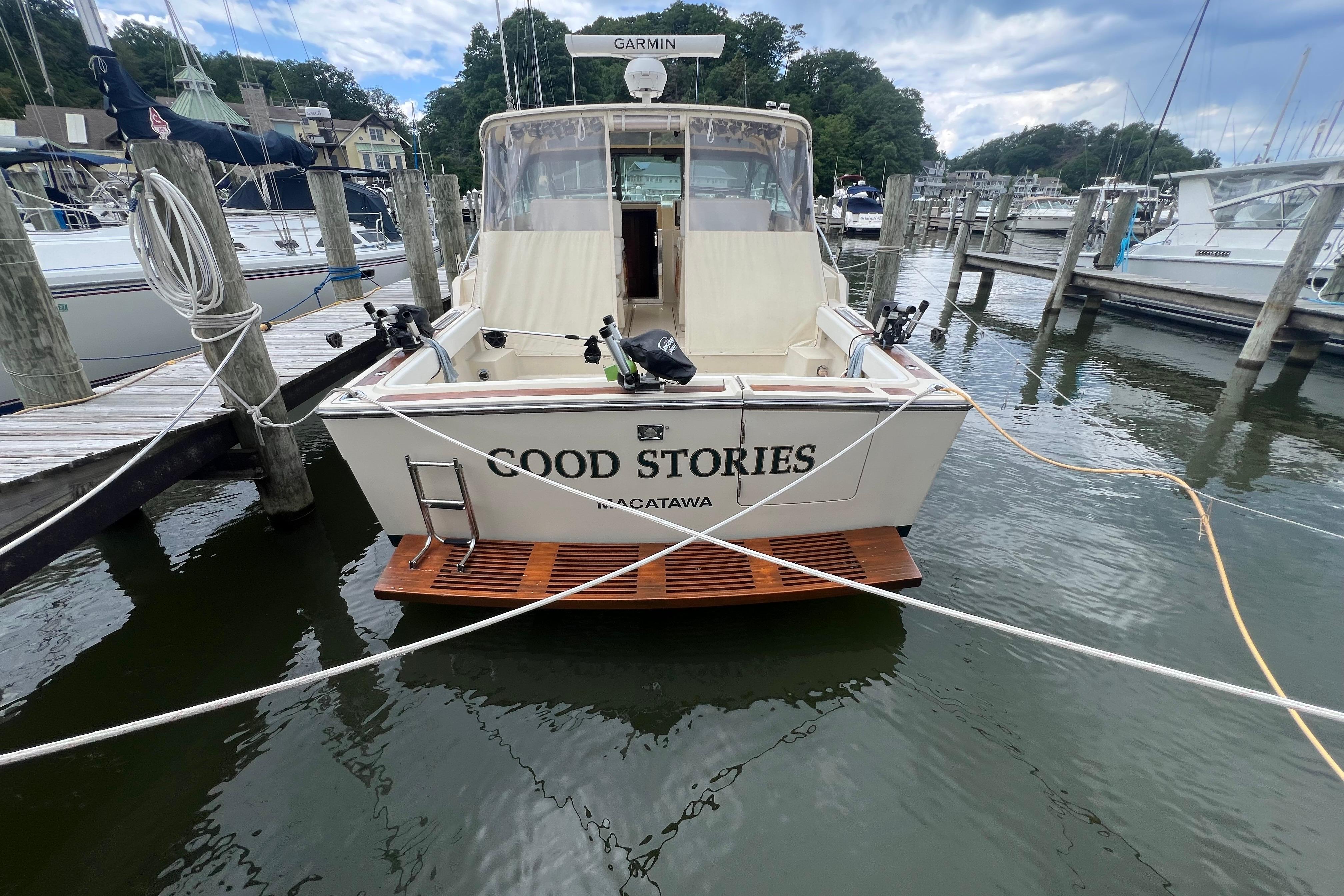 1985 Tiara 36 OPEN boat named "Good Stories" docked at a marina.