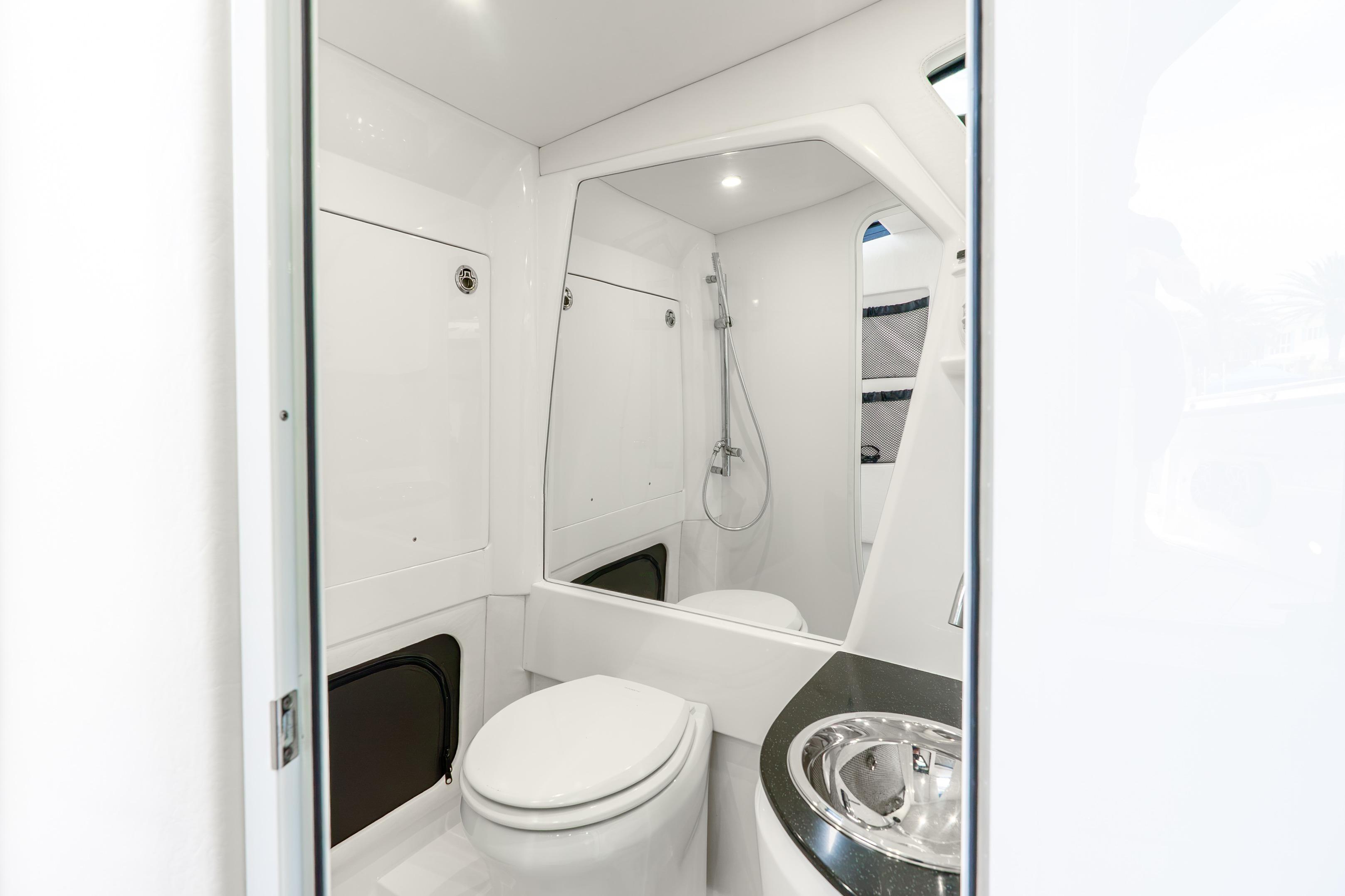 Luxurious bathroom interior of 2024 Nor-Tech 452 Super Fish boat, featuring modern fixtures.