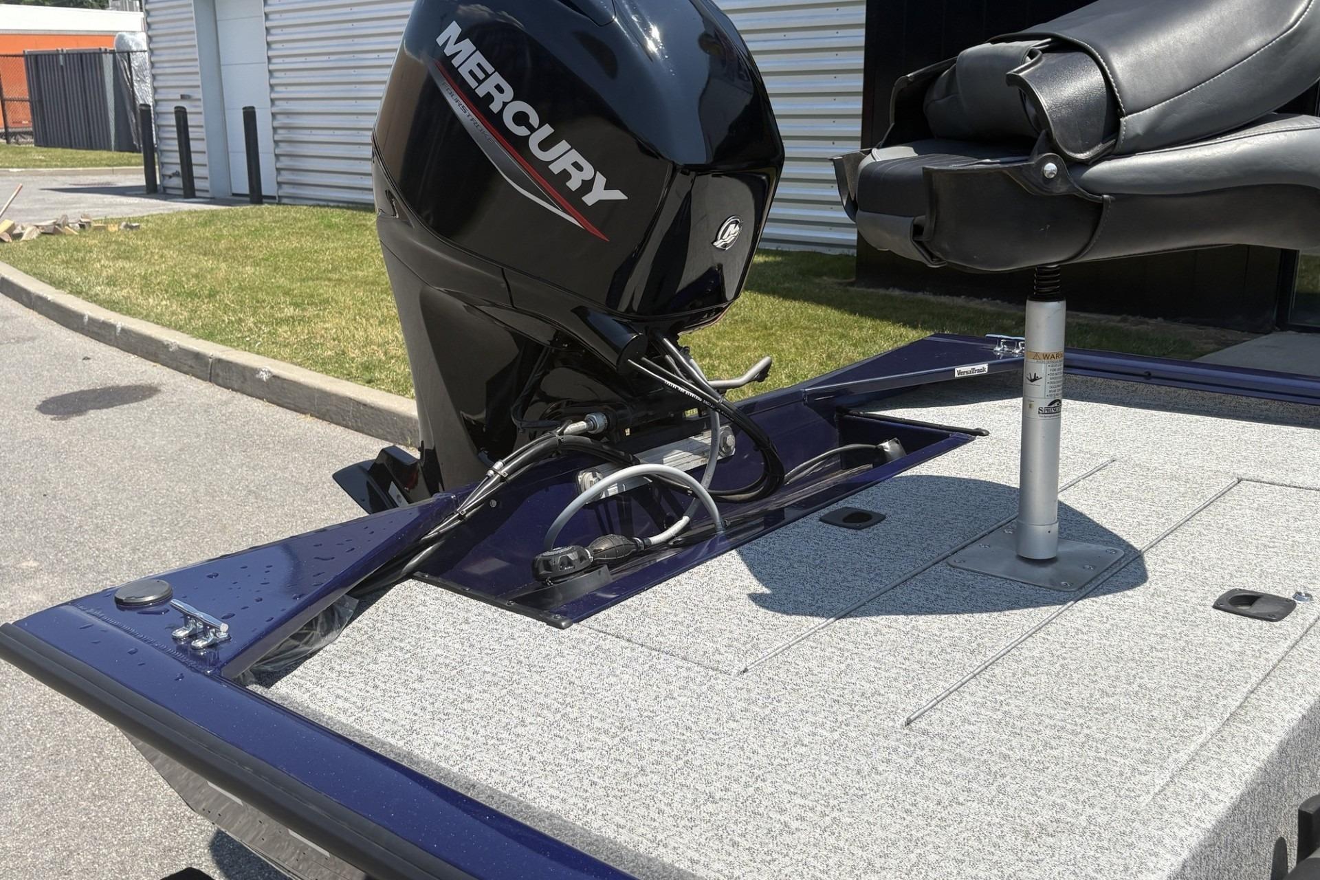 2020 Tracker Pro 170 boat with Mercury engine and swivel seat on a sunny day.
