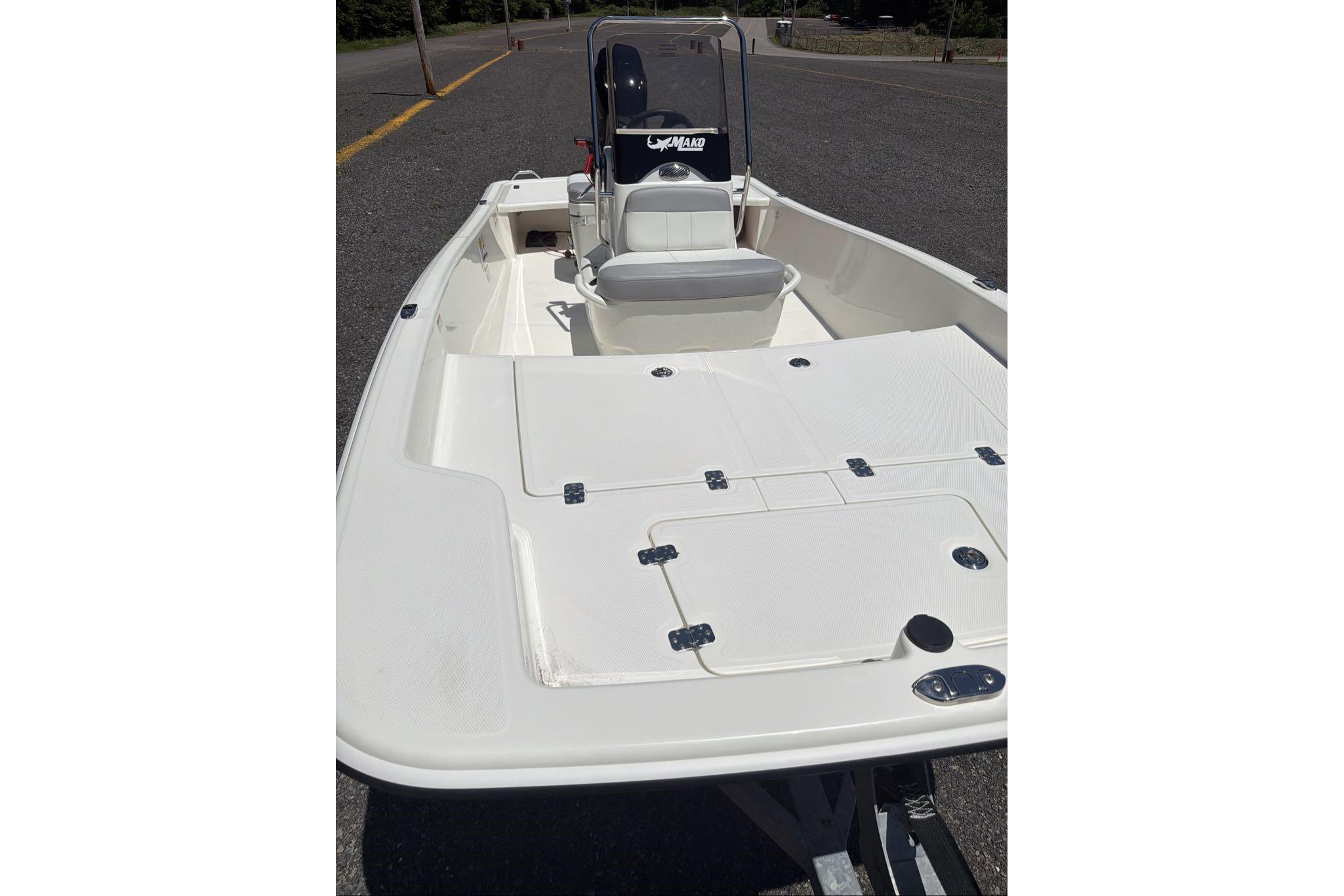 2026 Mako Pro Skiff 15 CC boat with open deck and console on a trailer.