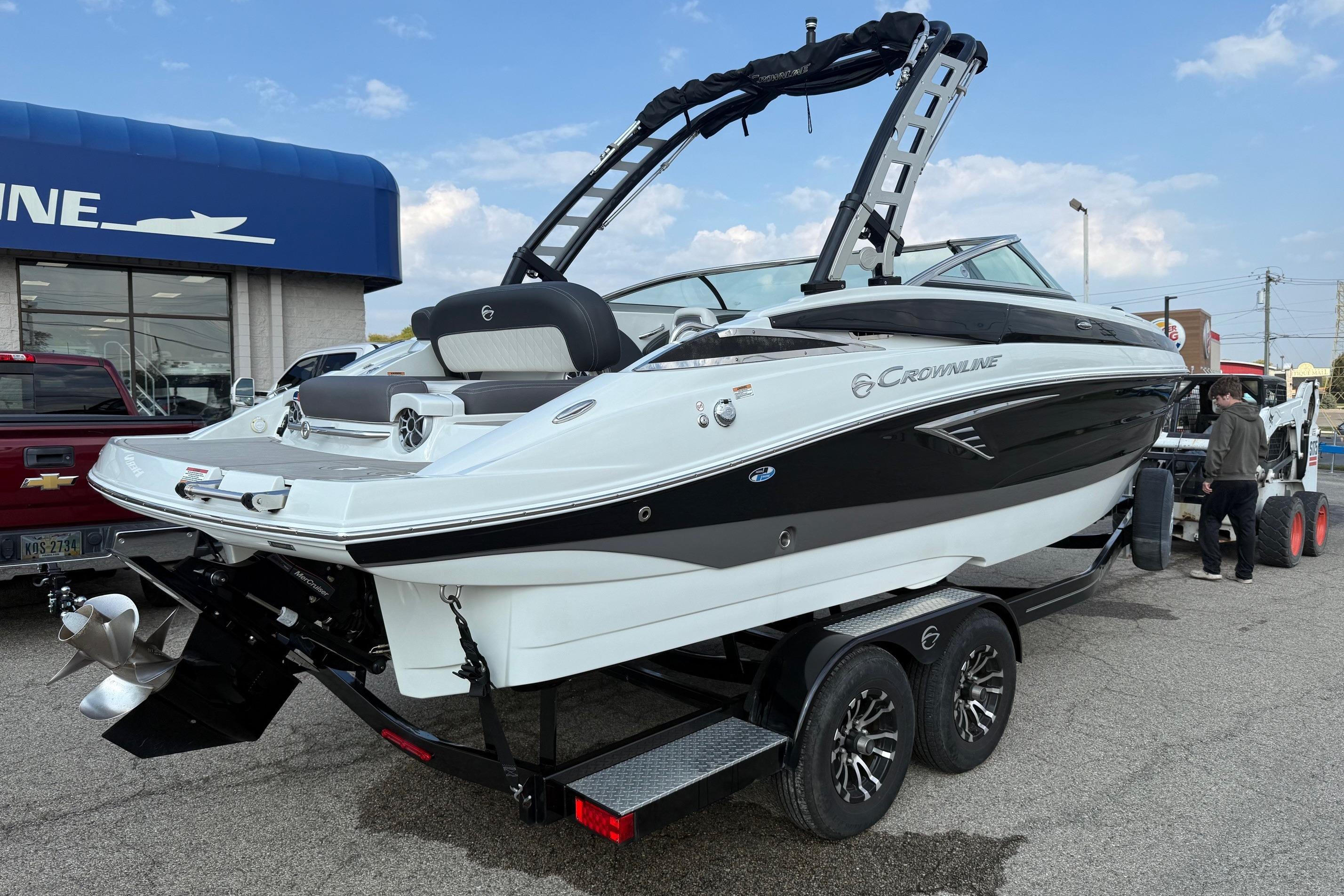 2023 Crownline 260 SS boat on trailer, displayed outdoors near dealership.