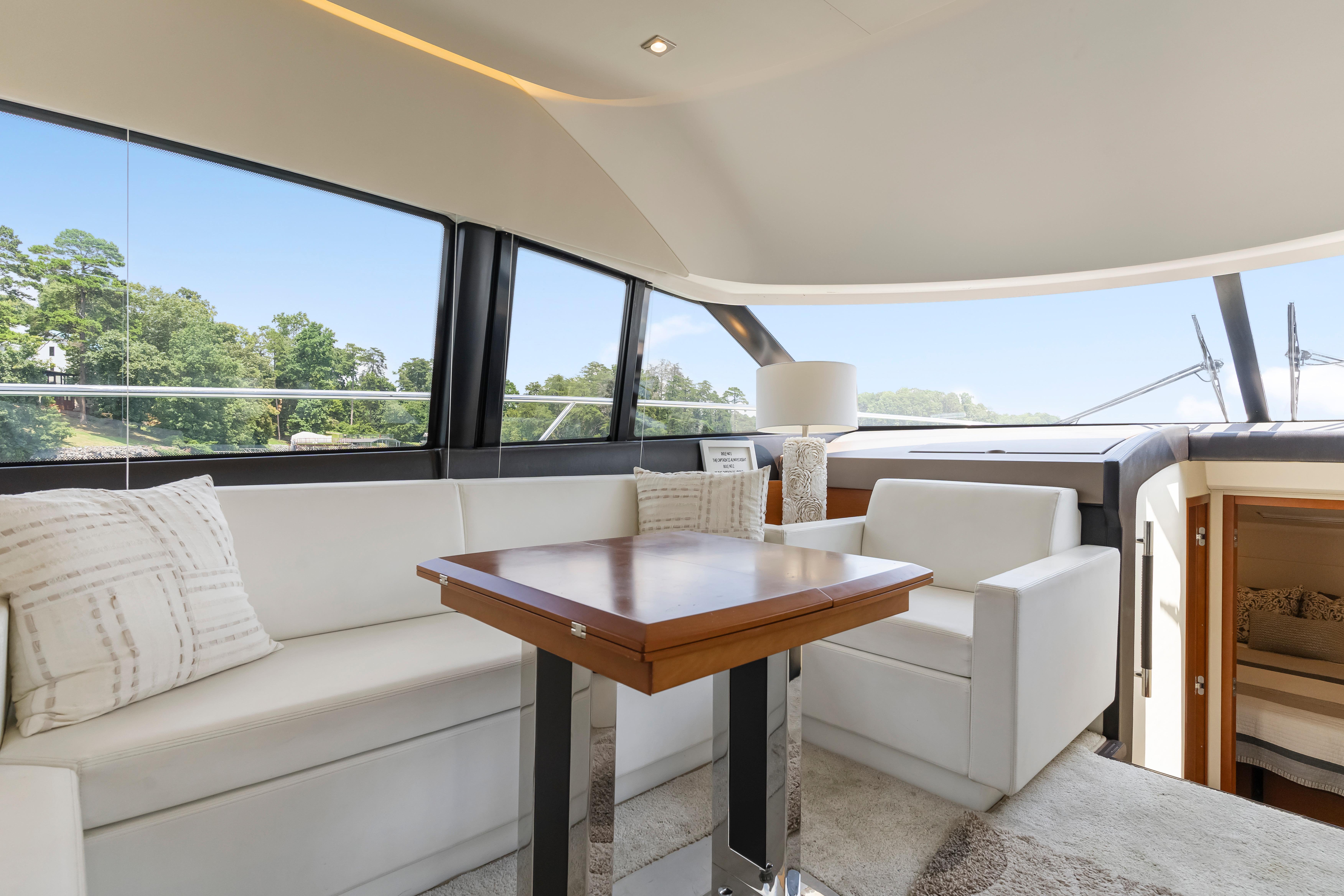 Luxurious interior of a 2017 Prestige 500 yacht with elegant seating and panoramic windows.