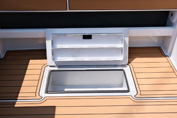 2023 Makaira Gen3 800 boat deck with open storage compartment.
