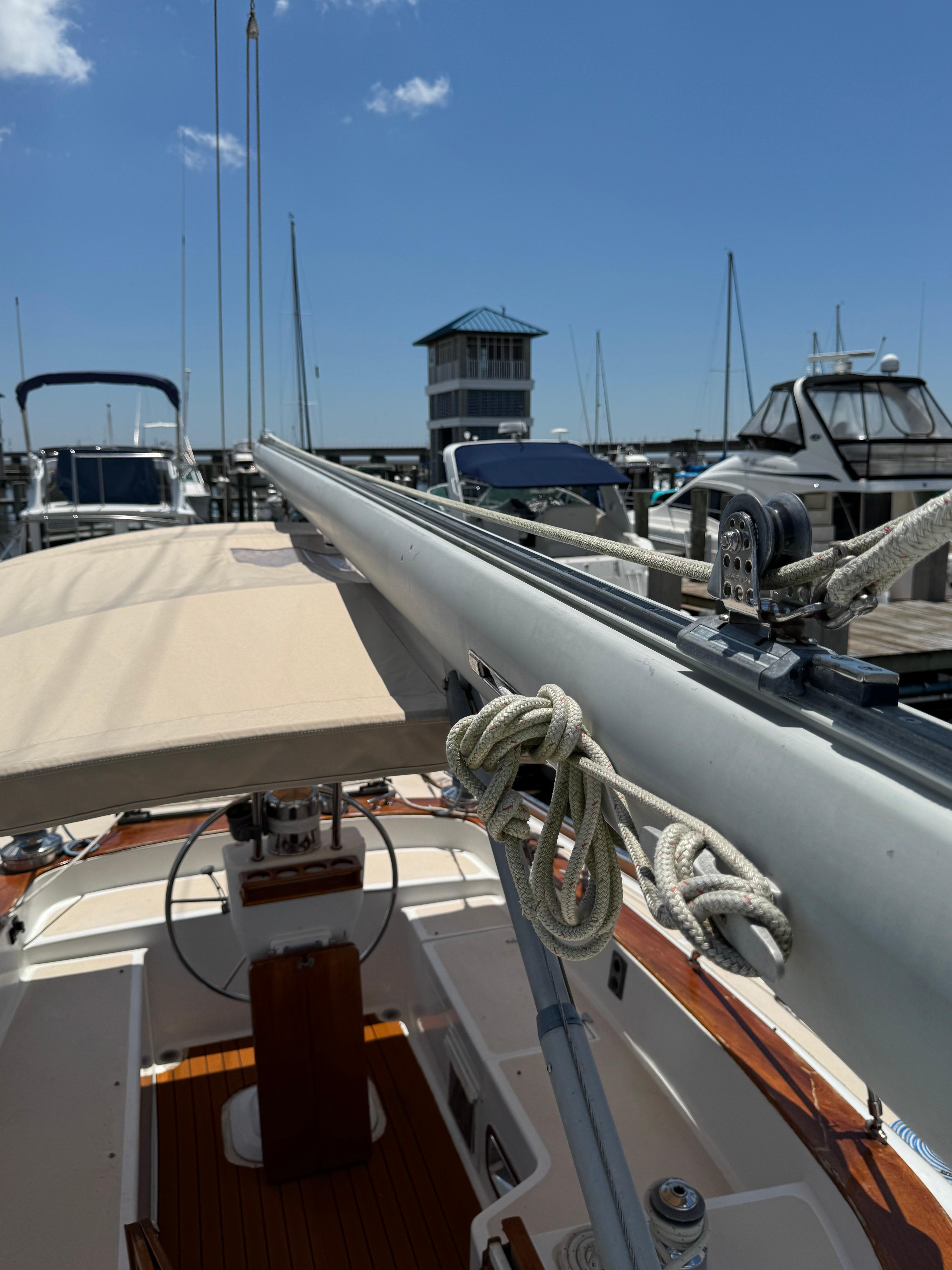 1981 Gulfstar 44 sailboat docked at marina, clear sky, visible rigging and helm.