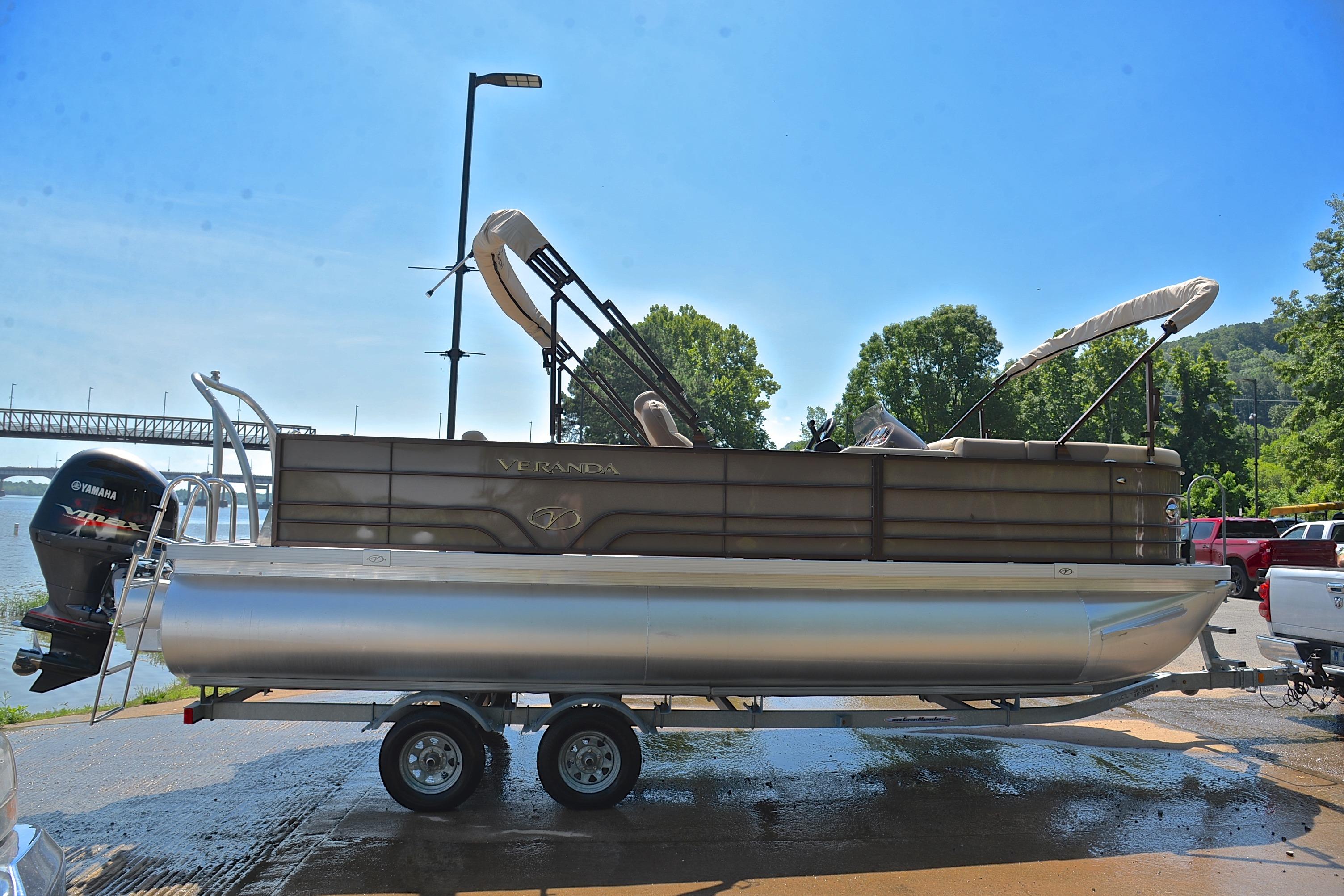 2020 Veranda VR22 pontoon boat on trailer by a river, sunny day.