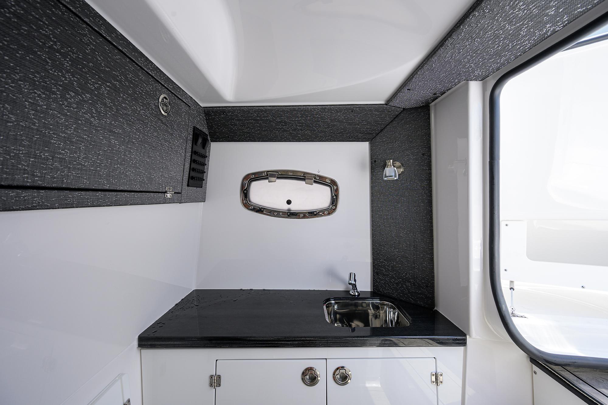 Interior of 2026 Monterey Elite 27 OB boat featuring a sleek sink and modern design.