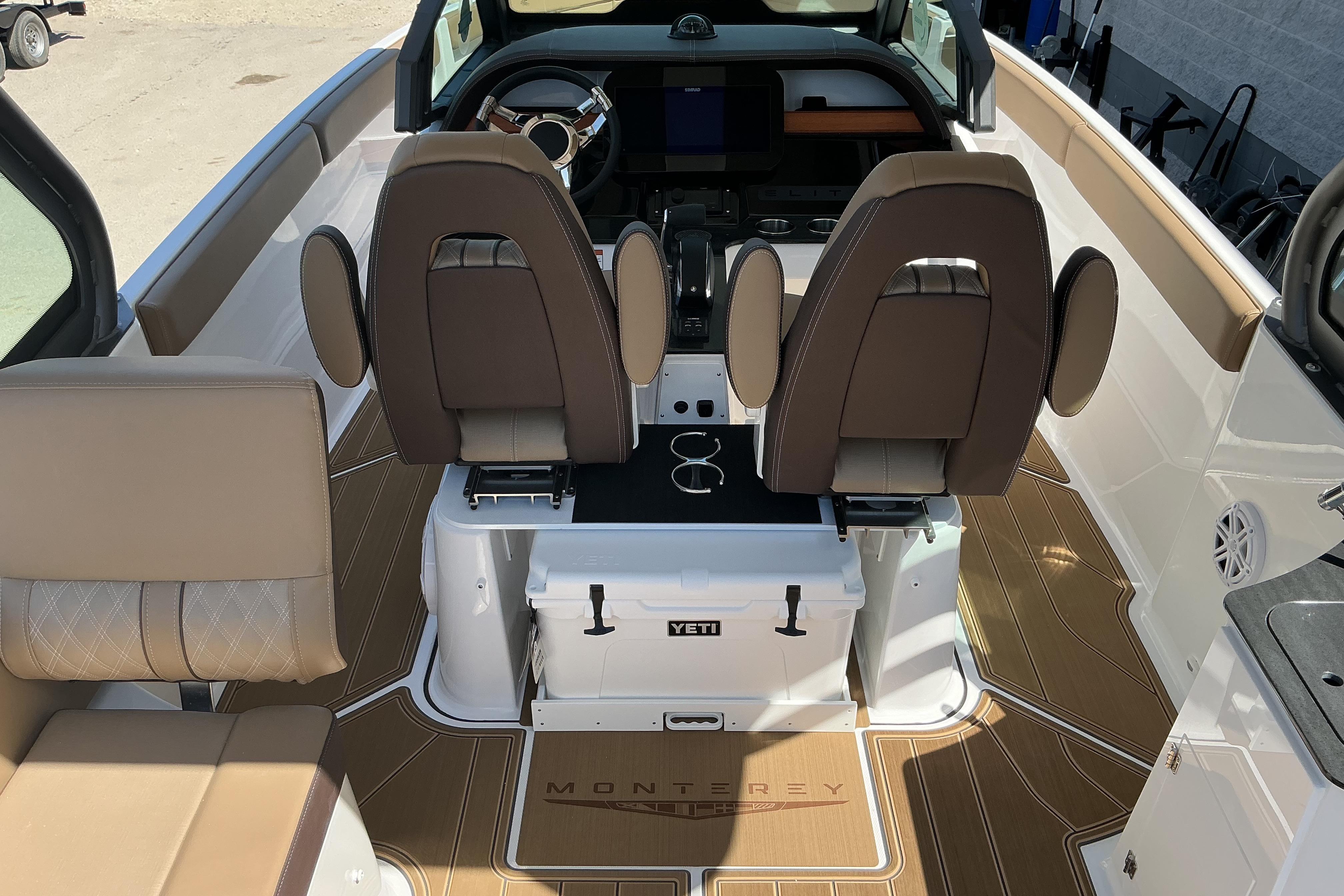 Interior of 2026 Monterey Elite 25 OB boat with luxurious seating and modern dashboard.