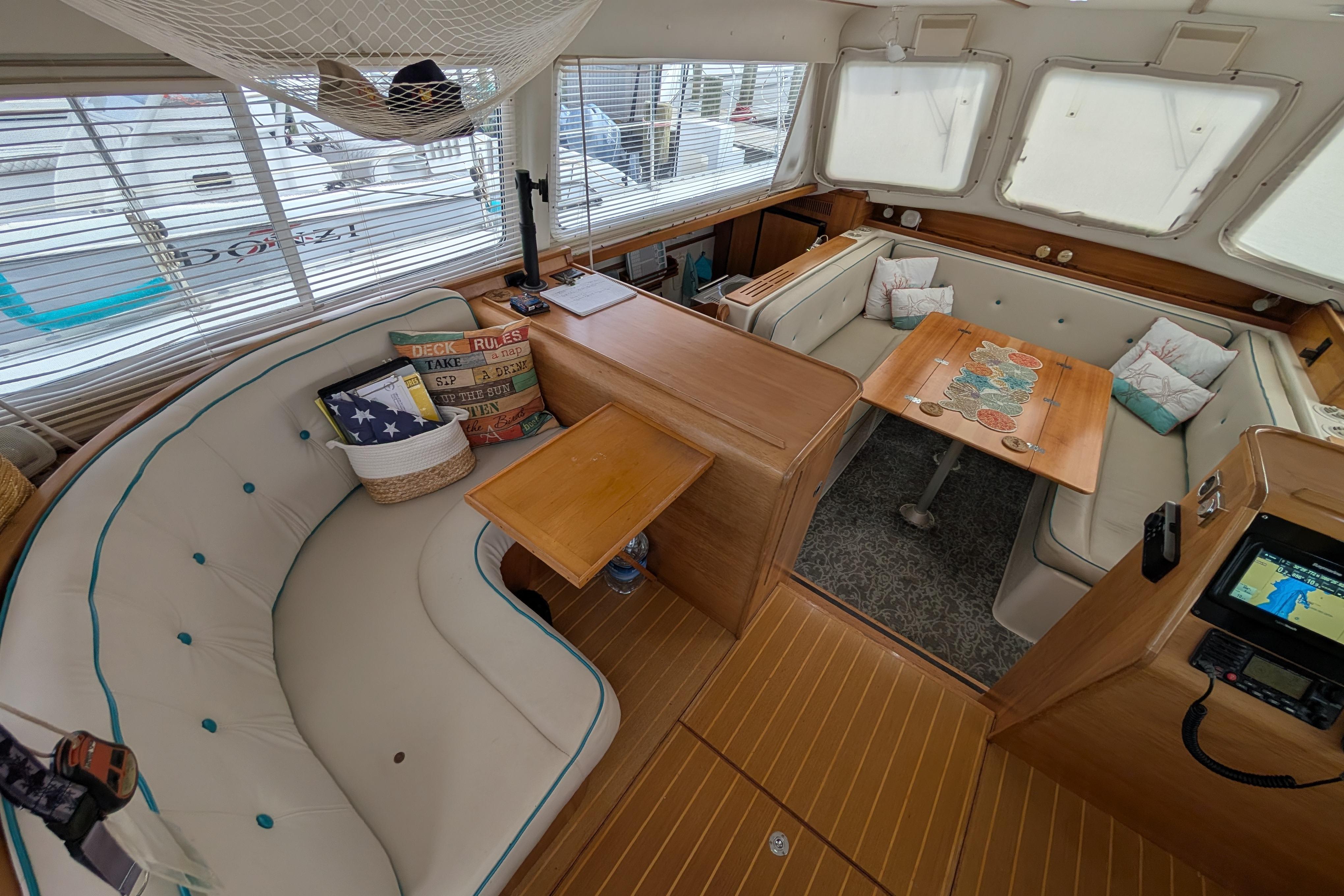 Interior of 2004 PDQ 34 Powercat with cozy seating and nautical decor.
