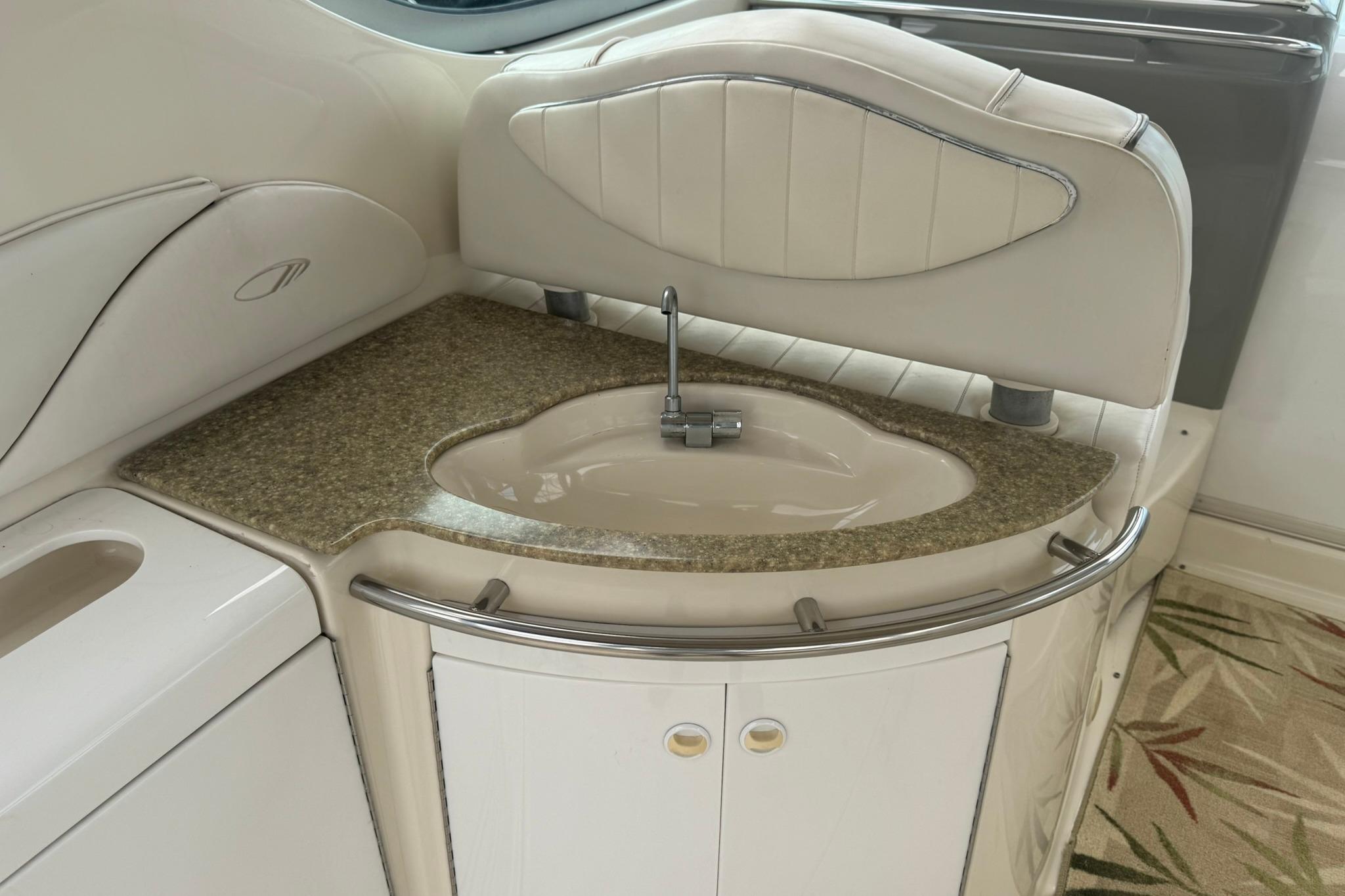 1998 Maxum 3700 SCR yacht interior with elegant sink and countertop design.