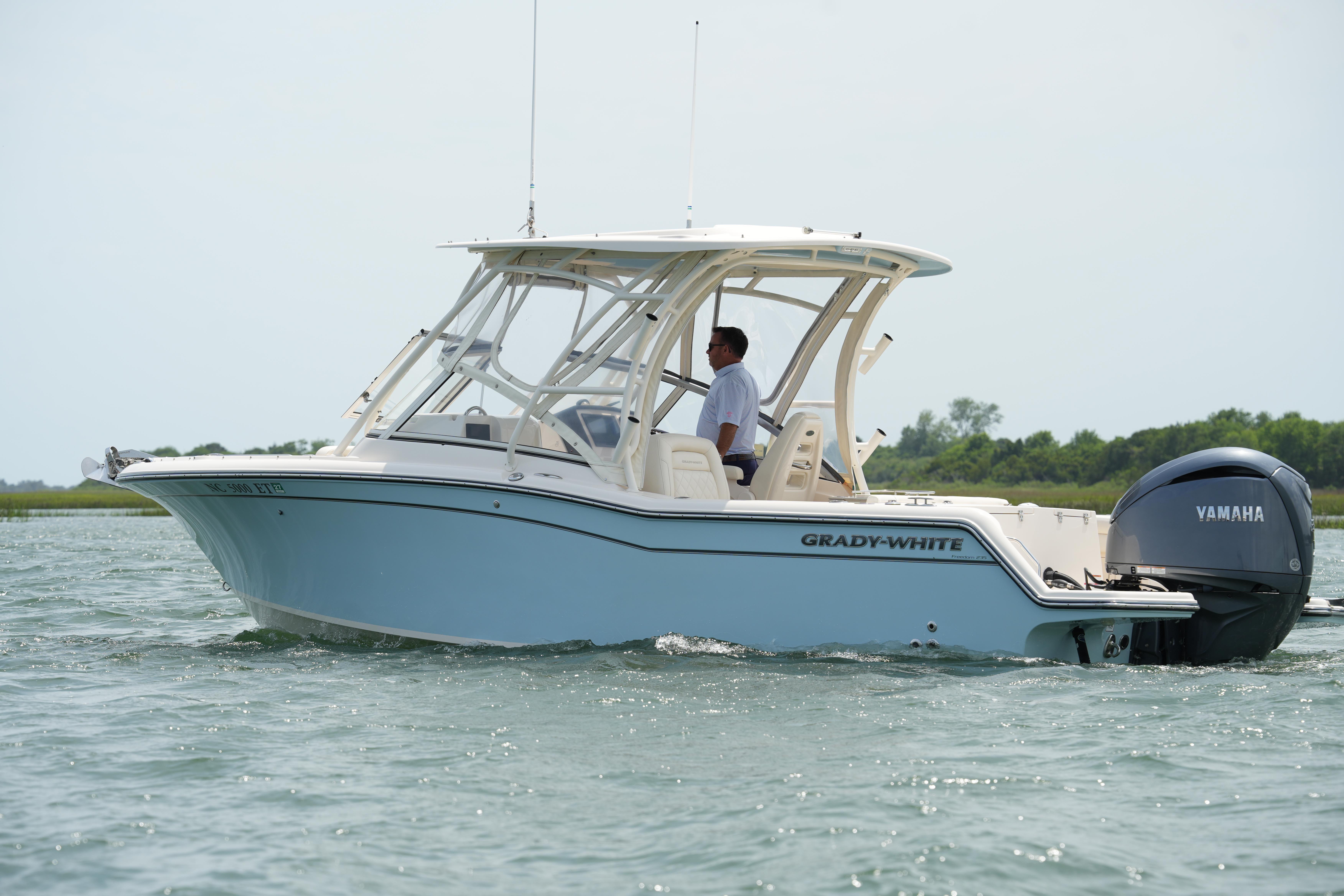2021 Grady-White Freedom 235 boat cruising on water with Yamaha engine.