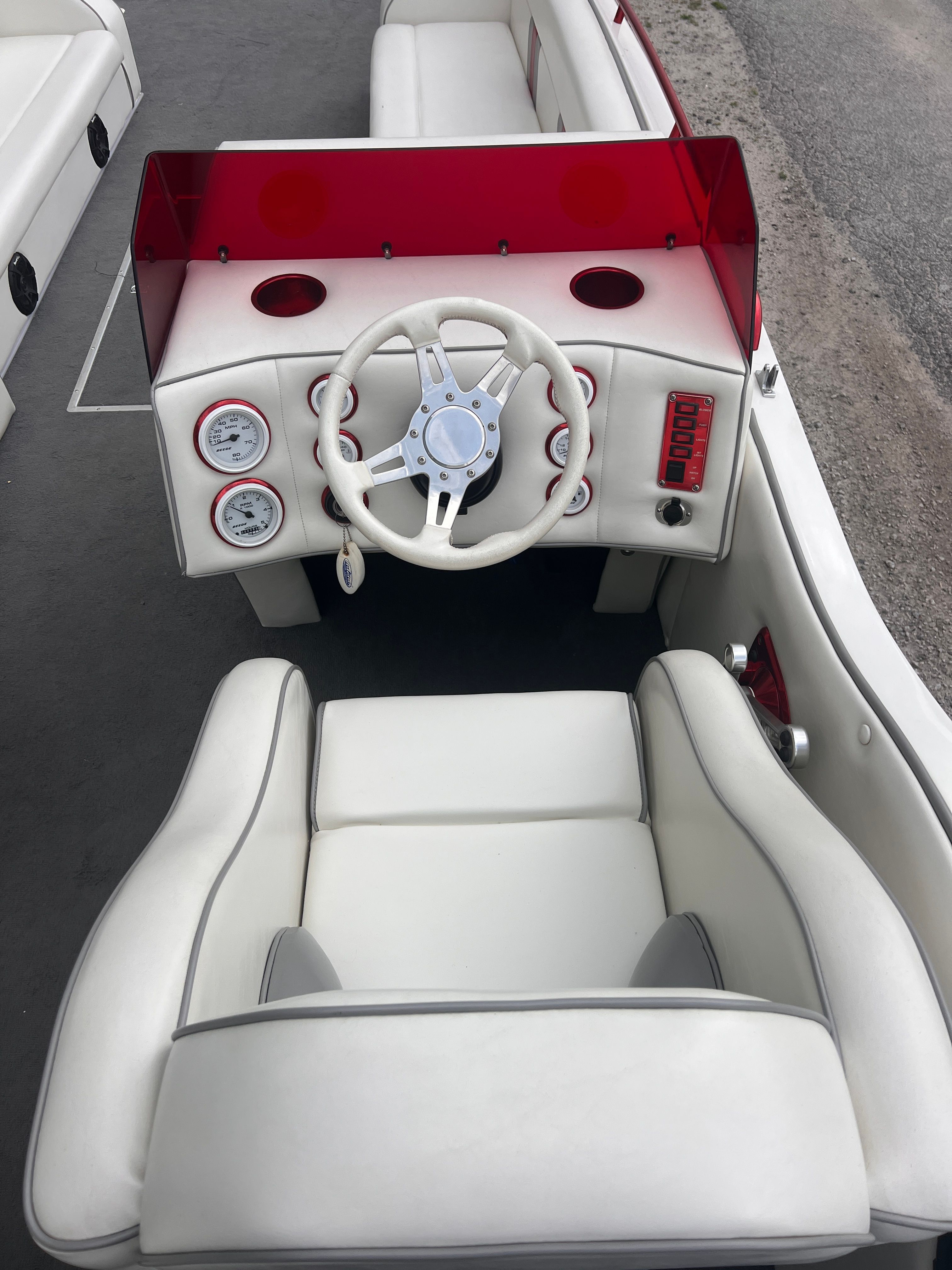 Interior of a 2008 Cheetah Fastcat with white seating and red dashboard.