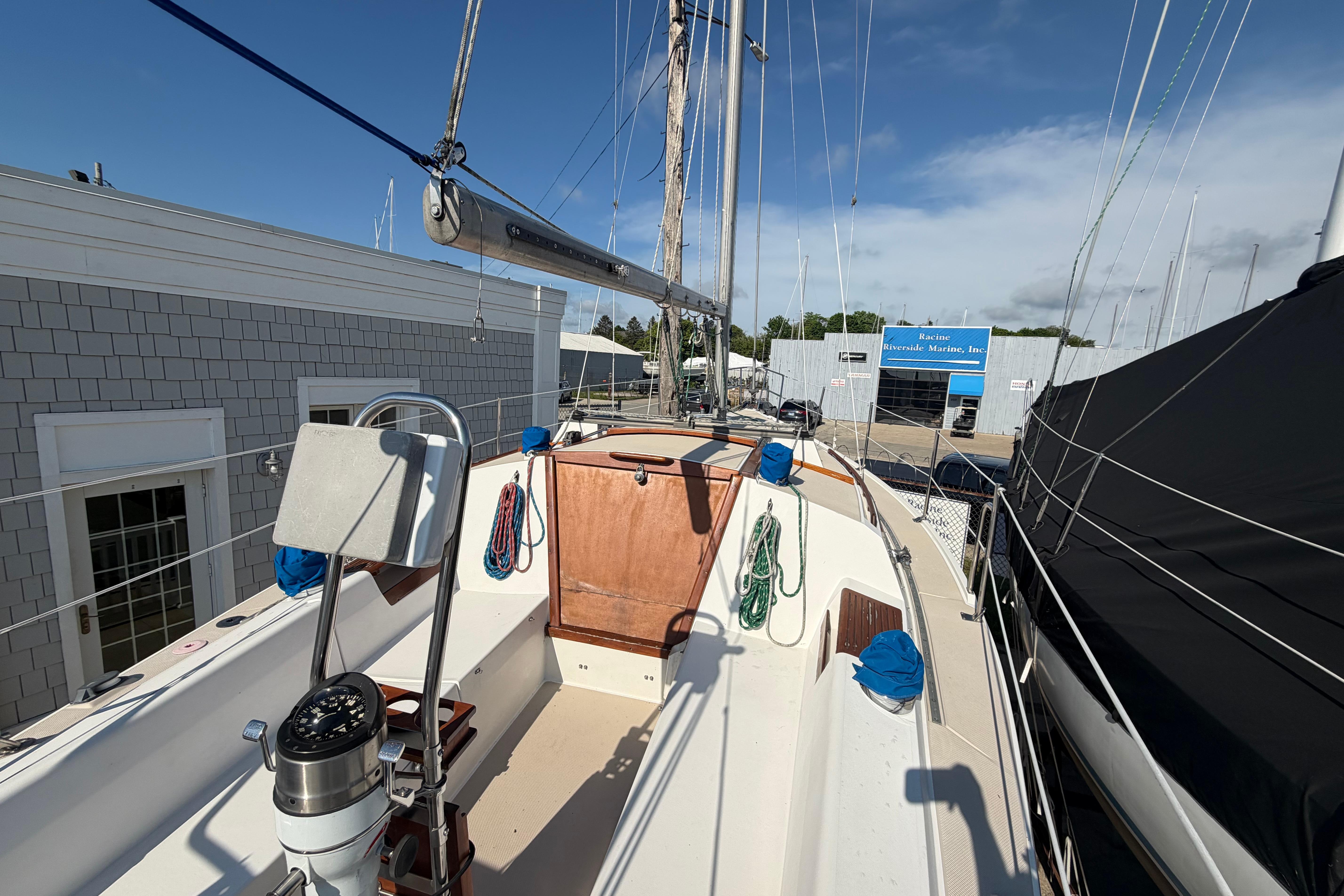 1988 Catalina 30 MkII sailboat deck view at marina, showcasing cockpit and rigging.