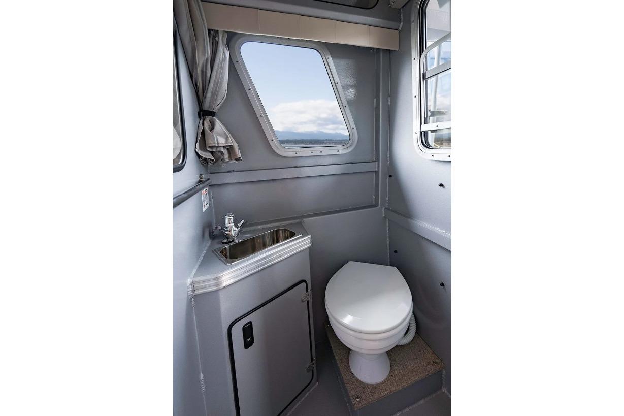 Interior of 2026 KingFisher 3225 GFX Offshore boat bathroom with sink and toilet.
