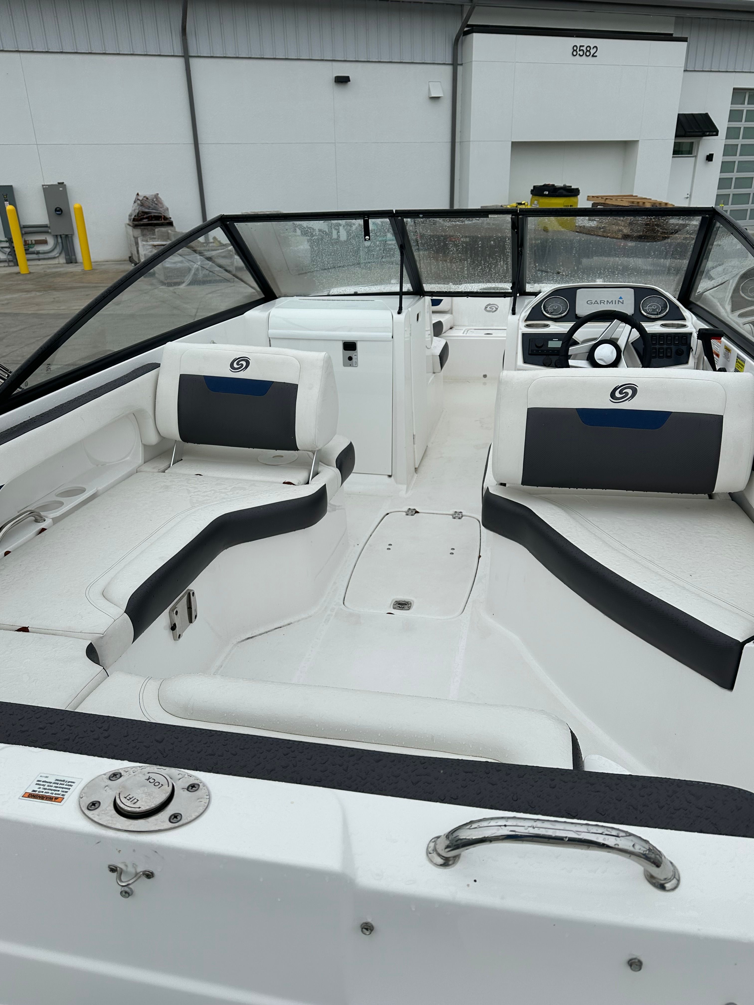 Interior of a 2022 Hurricane 235SD boat, white and blue seating.