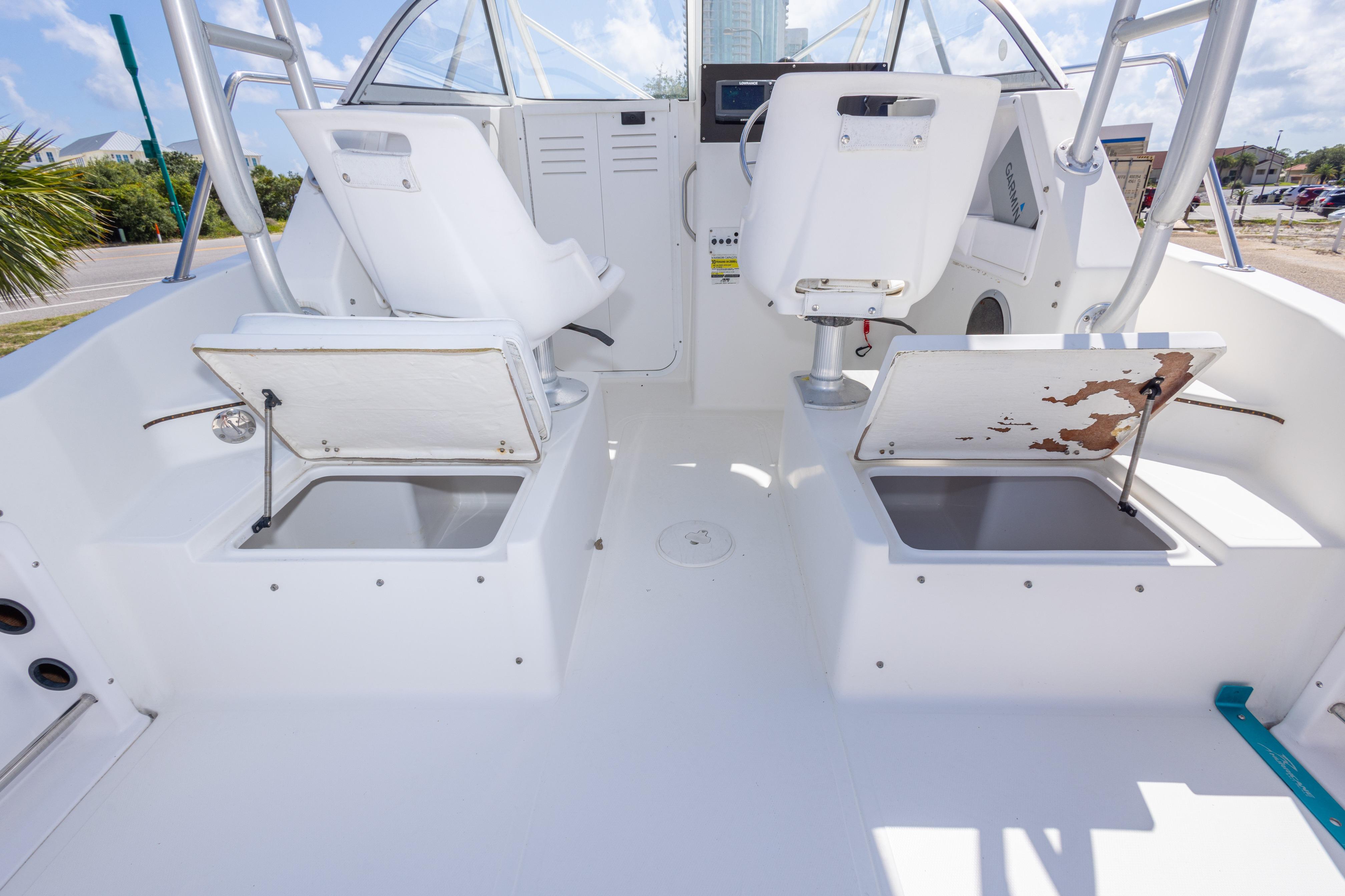 2007 Sea Boss 235 Walkaround boat interior with open storage compartments and seating.