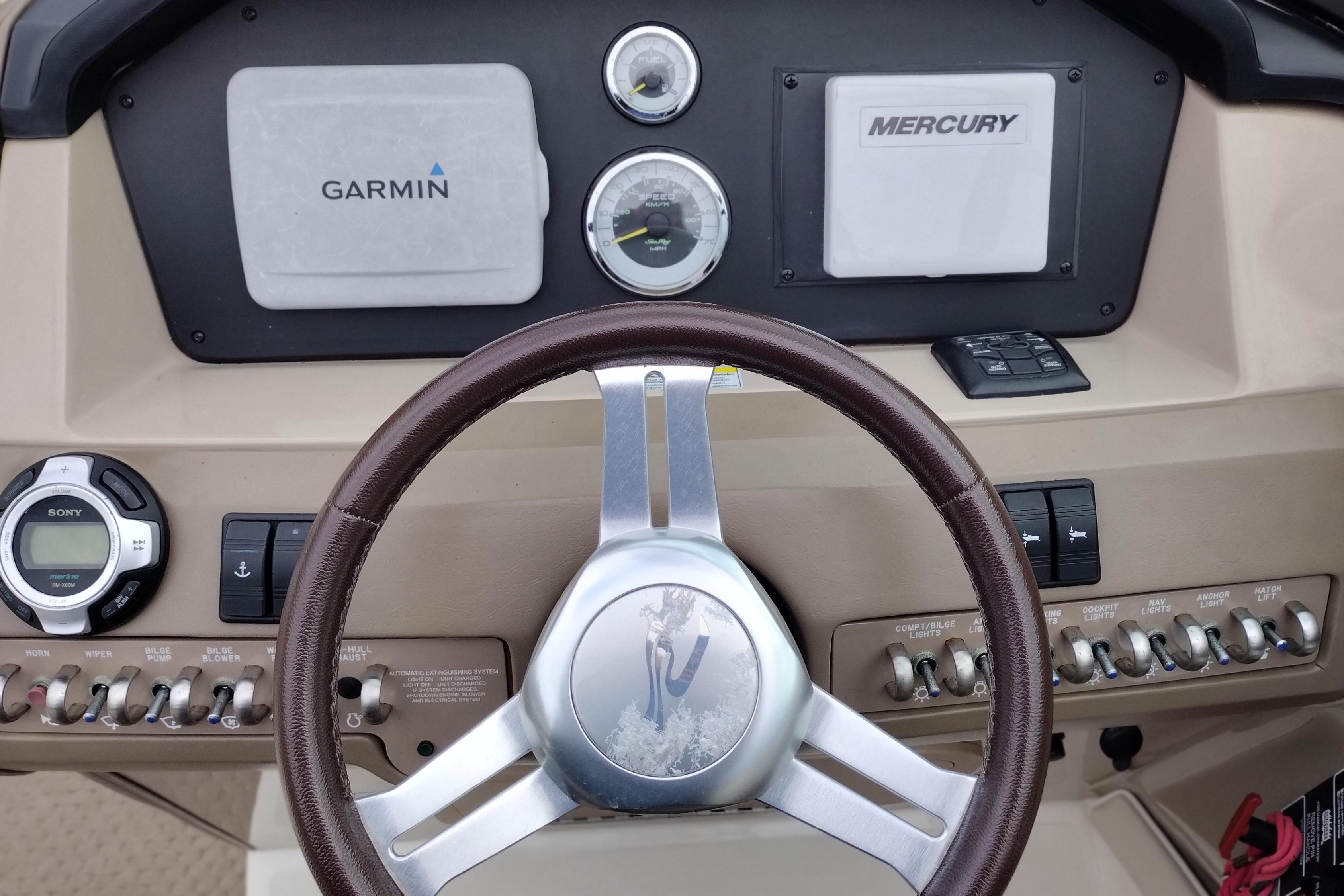 Steering console of 2013 Sea Ray 300 SLX with Garmin and Mercury displays.