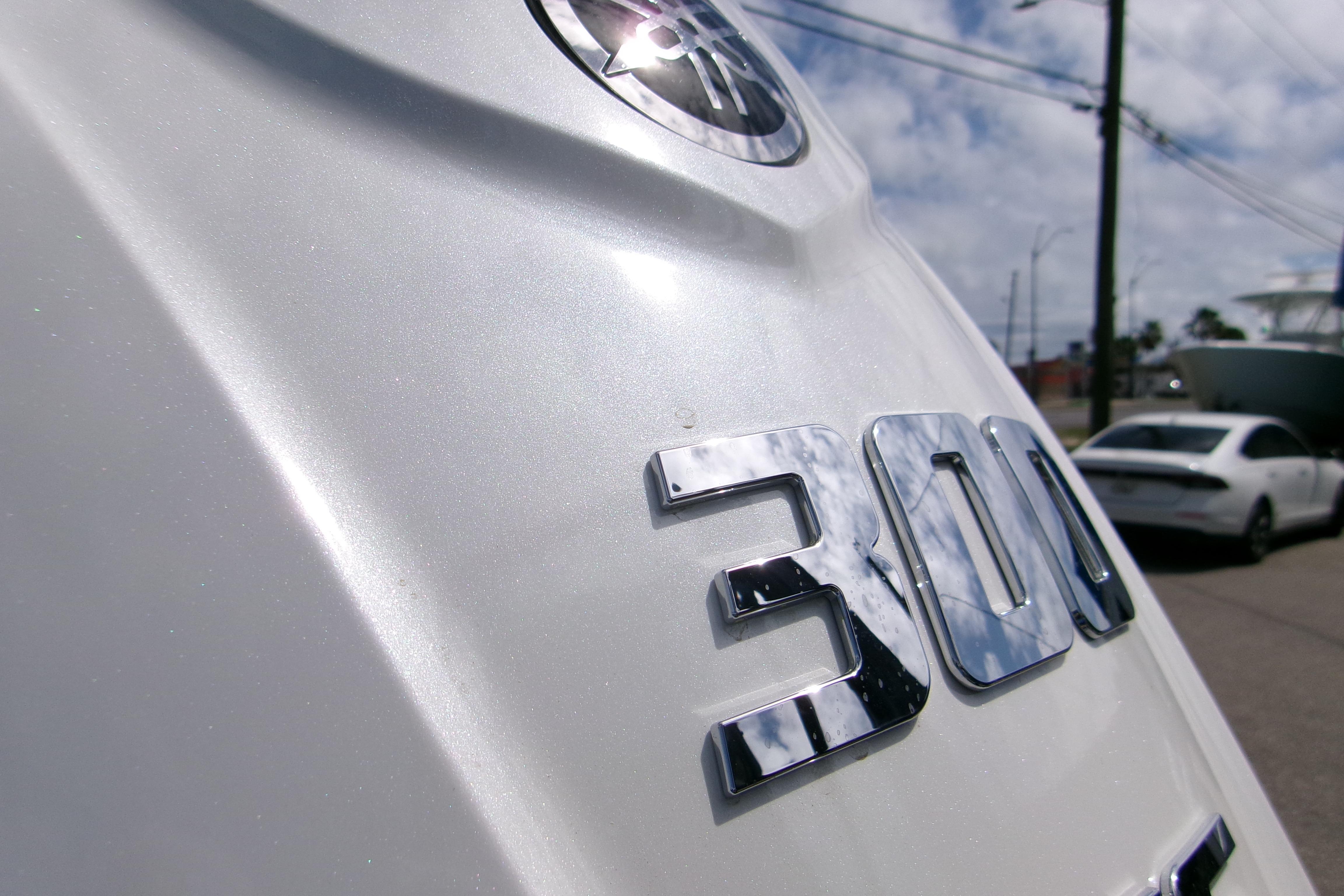 Close-up of a 2026 Sportsman Open 232 Center Console boat engine with "300" emblem.
