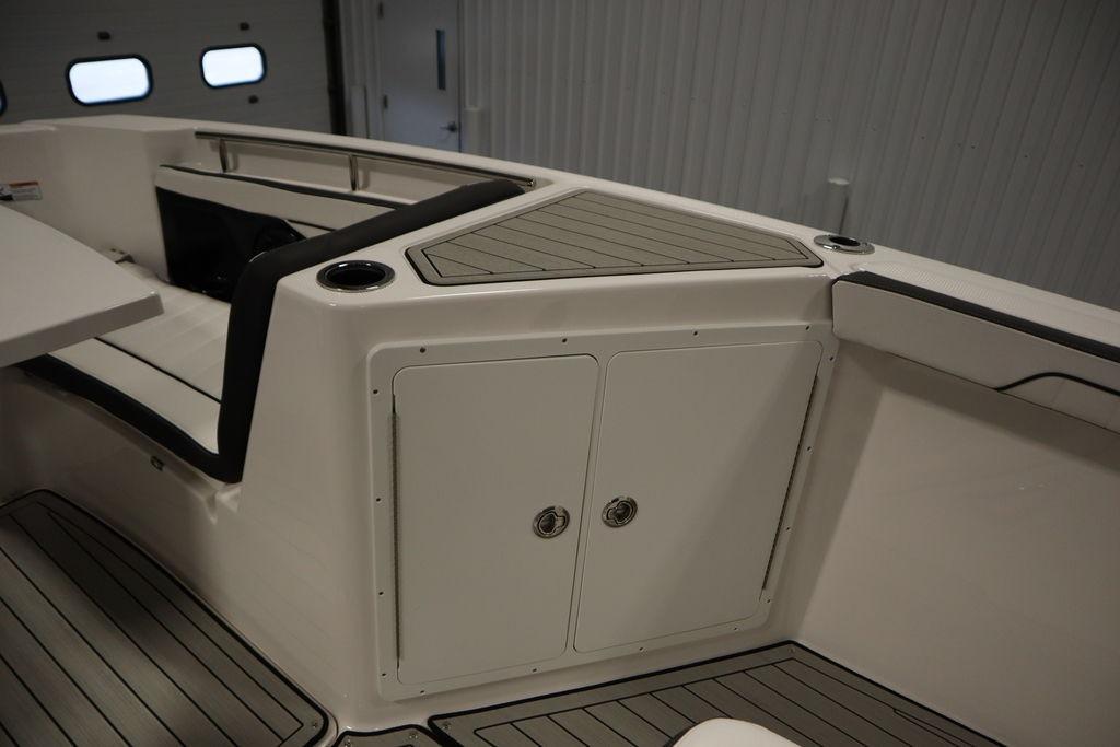 2026 Yamaha Boats 255 FSH Sport E interior with seating and storage compartments.