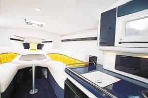 Interior of a 2001 Donzi Daytona 45 ZX with cozy seating area and kitchenette.