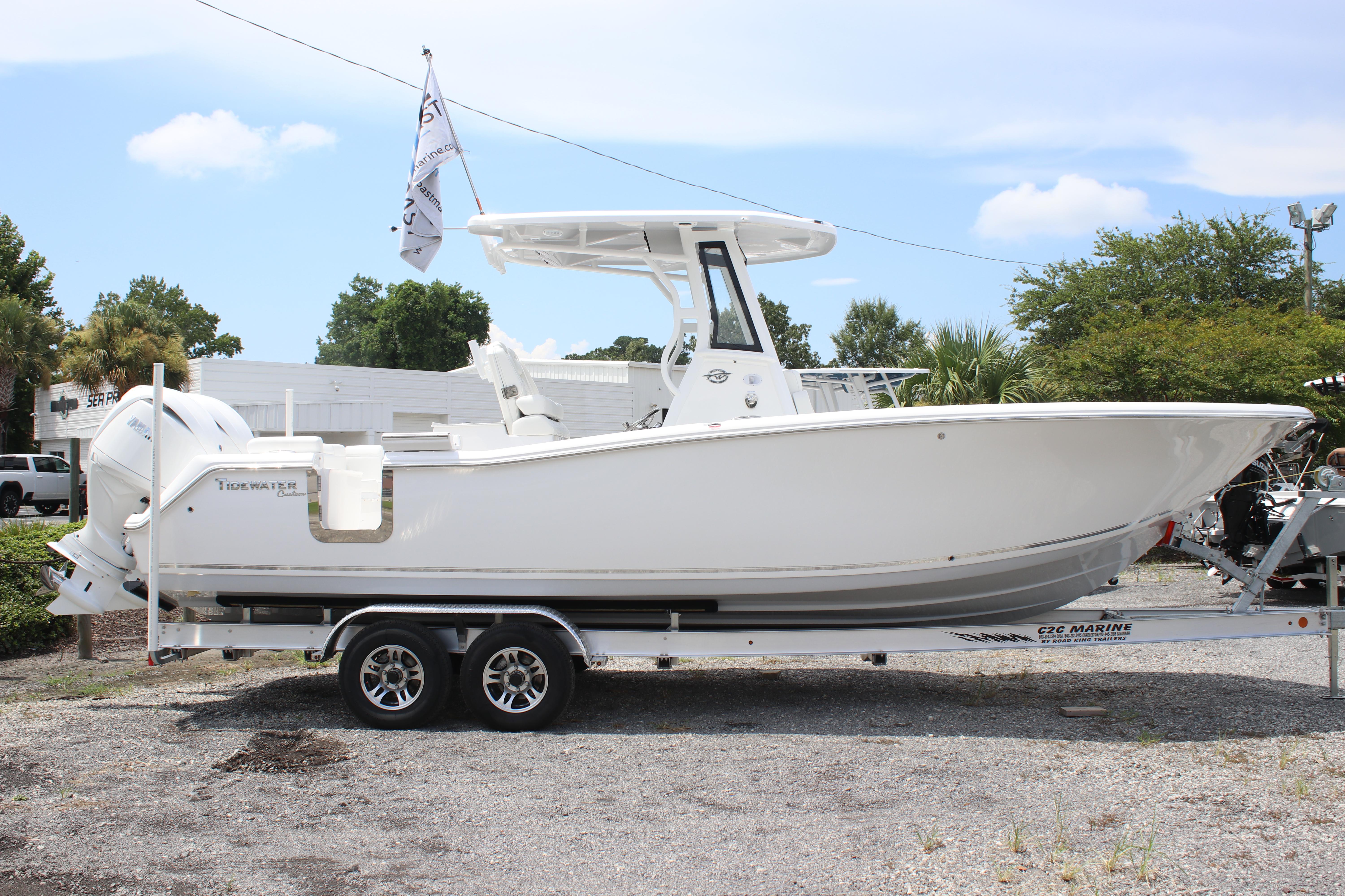 2026 Tidewater 272 LXF boat on trailer, parked outdoors under a clear sky.