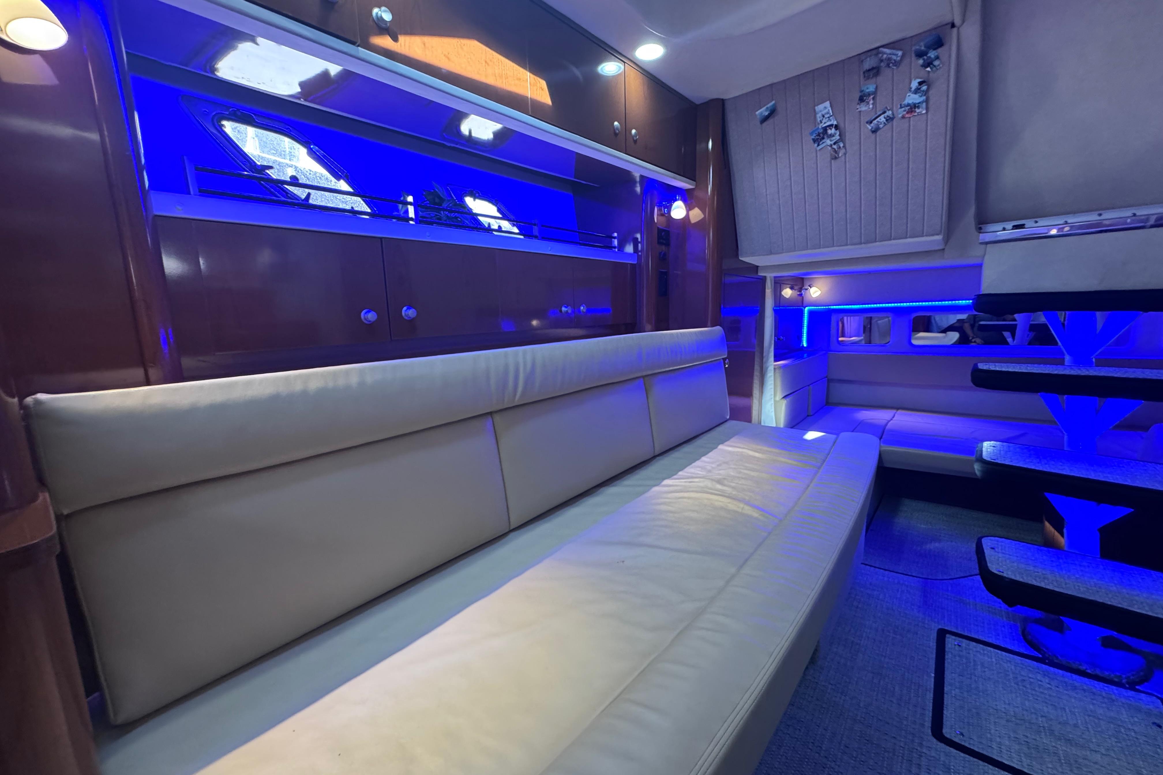 Luxurious interior of 2008 Sea Ray 350 Sundancer with blue ambient lighting and leather seating.