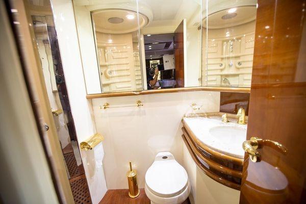 Luxurious bathroom in 2003 Azimut 74 Solar yacht with elegant fixtures and mirrored walls.