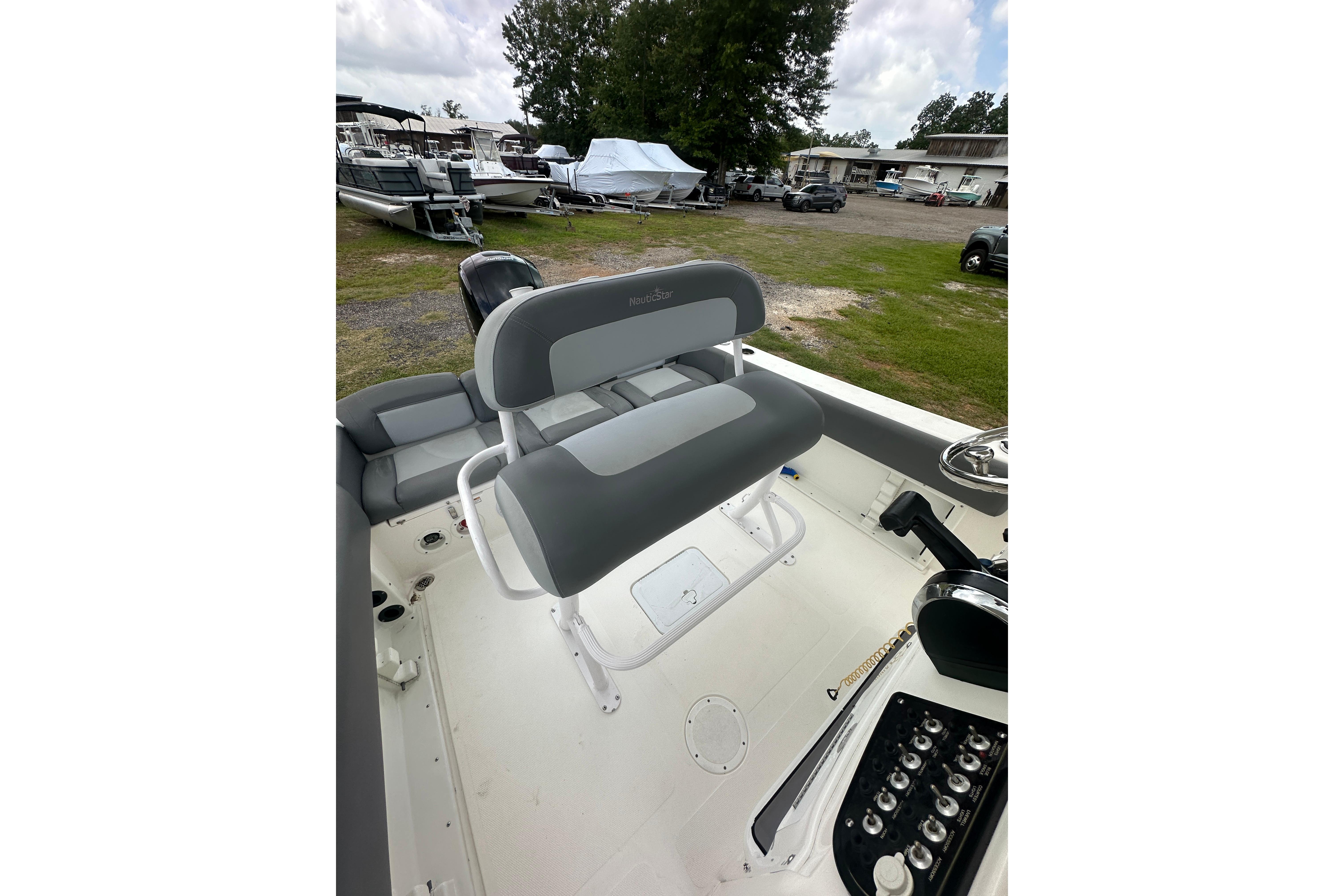 2023 NauticStar 2102 Legacy boat interior with gray seating and control panel.