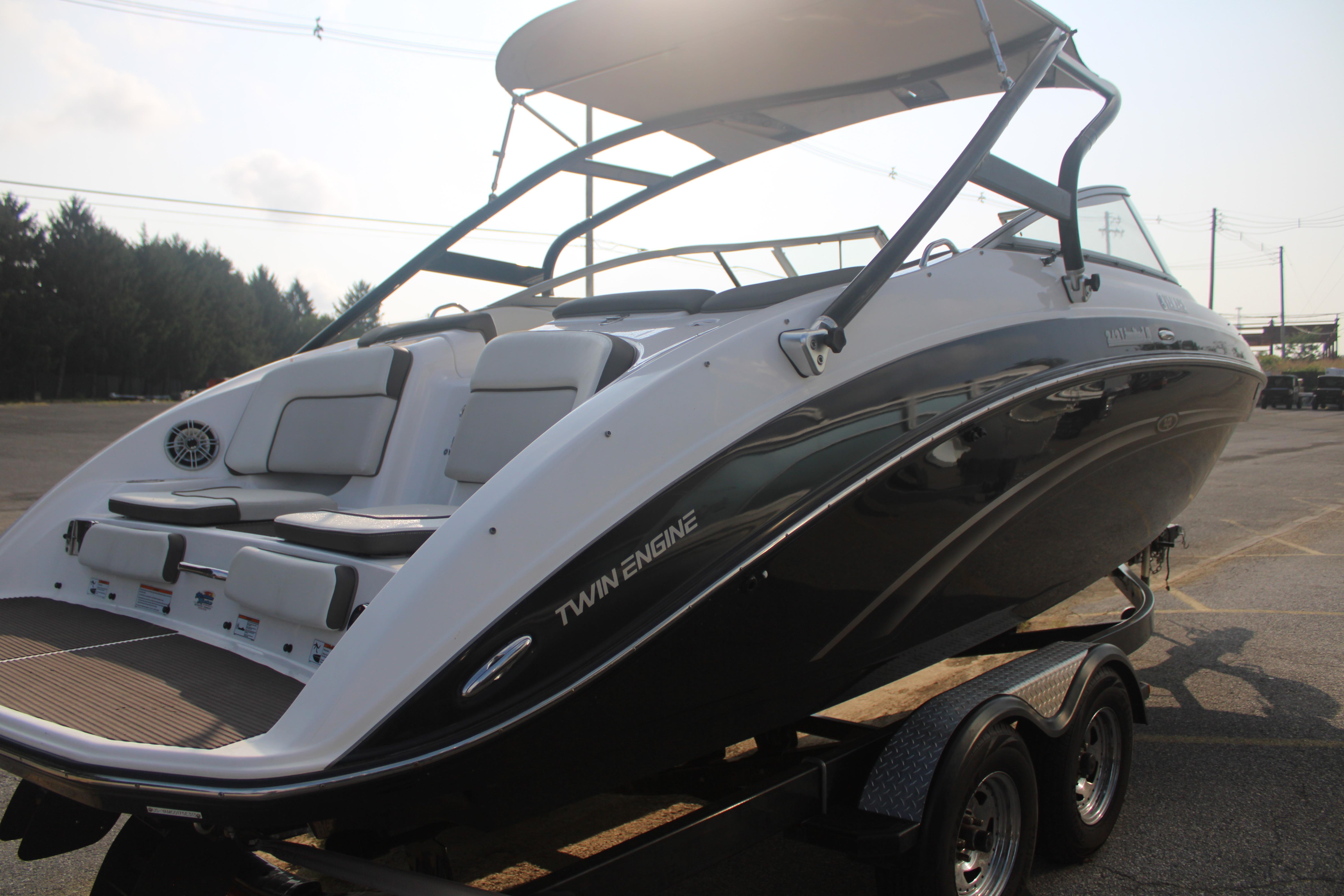 2013 Yamaha Boats 242 Limited S on trailer, showcasing sleek design and twin engines.