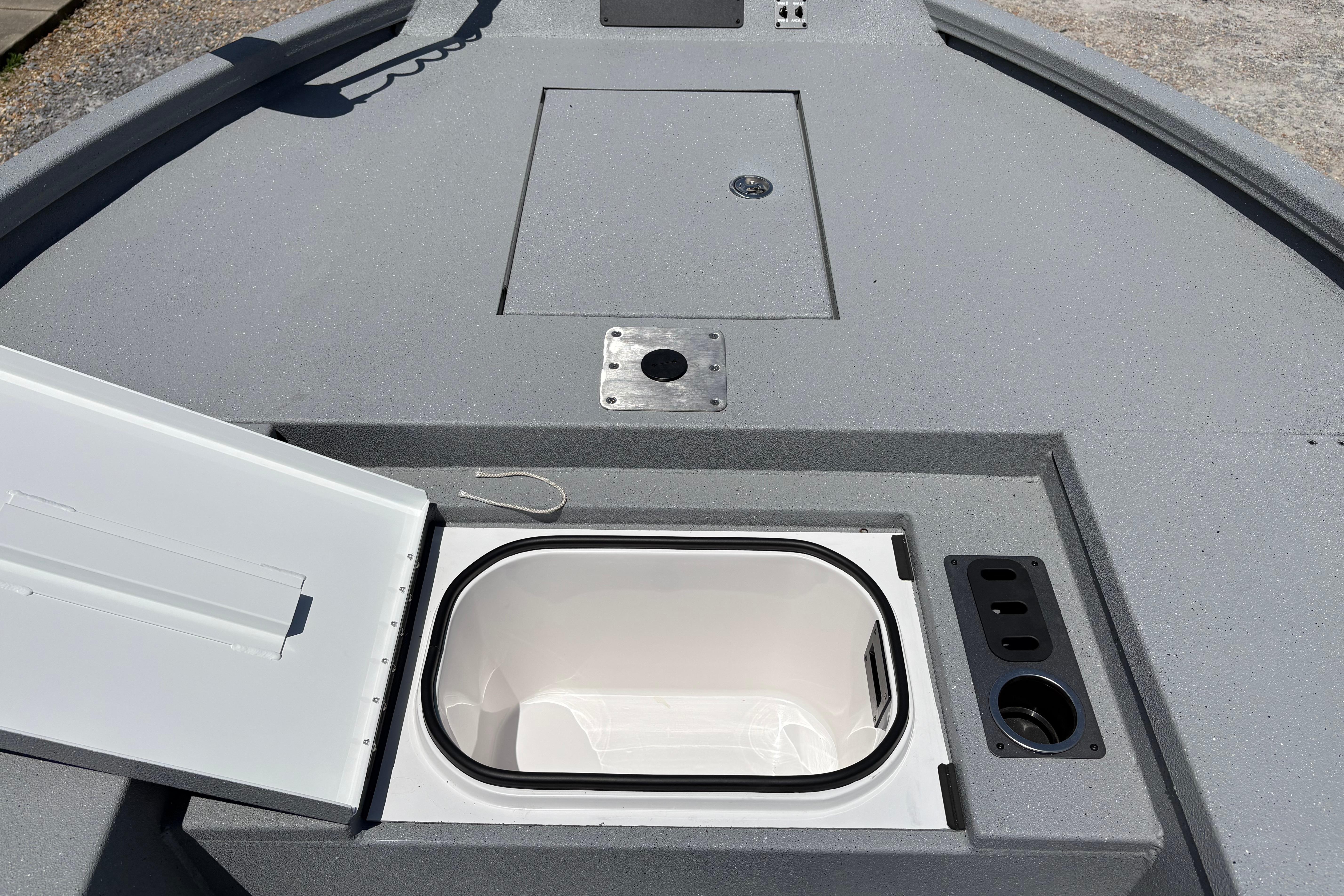 2026 Vexus ACX 2150 boat deck with open storage compartment and cup holders.