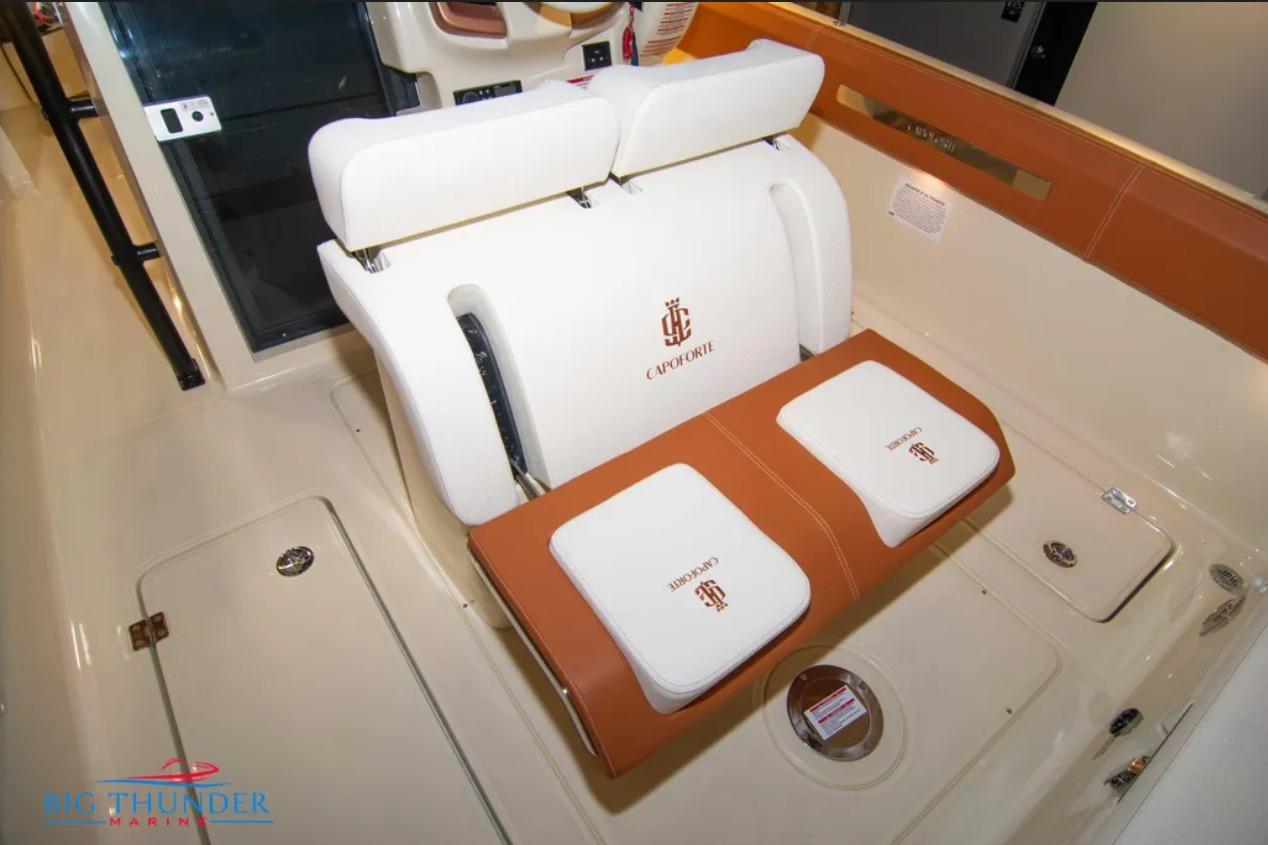 2024 Capoforte FX270 boat interior with white and brown seating, featuring Capoforte branding.